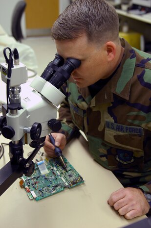 Tech. Sgt. David Decker, Air Force Repair Enhancement Program technician, repairs a component on a circuit card assembly of an eight-millimeter aircraft recorder Feb. 6 here. Sergeant Decker has a miniature micro-soldering certification and can repair parts as small as a 120-pin microchip. 
(U.S. Air Force photo by Staff Sgt. Erin T. Worley)