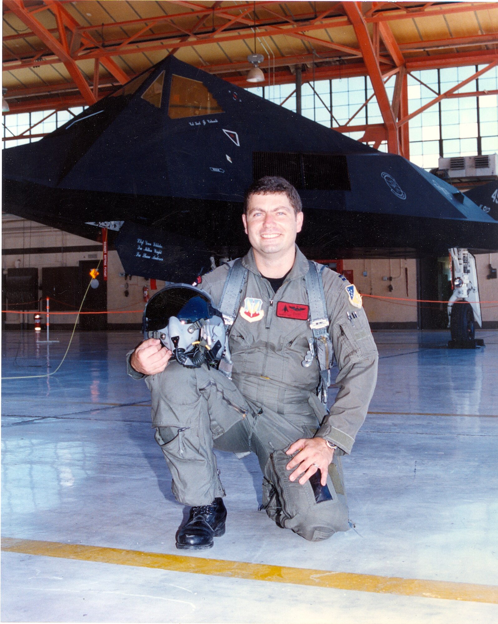 Maj Marcus “COOP” Cooper, III, an instructor pilot with the 49th Fighter Training Squadron, sits in front of an F-117 Nighthawk; one of the numerous aircraft the major has flown in and taught others to fly in his 24-year-career. (U.S. Air Force courtesy photo)