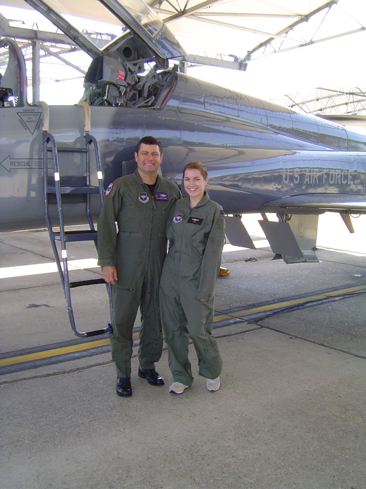 Major Cooper stands with his daughter, Stephanie Cooper, in front of a T-38C Talon prior to their father-daughter taxi. (U.S. Air Force courtesy photo)