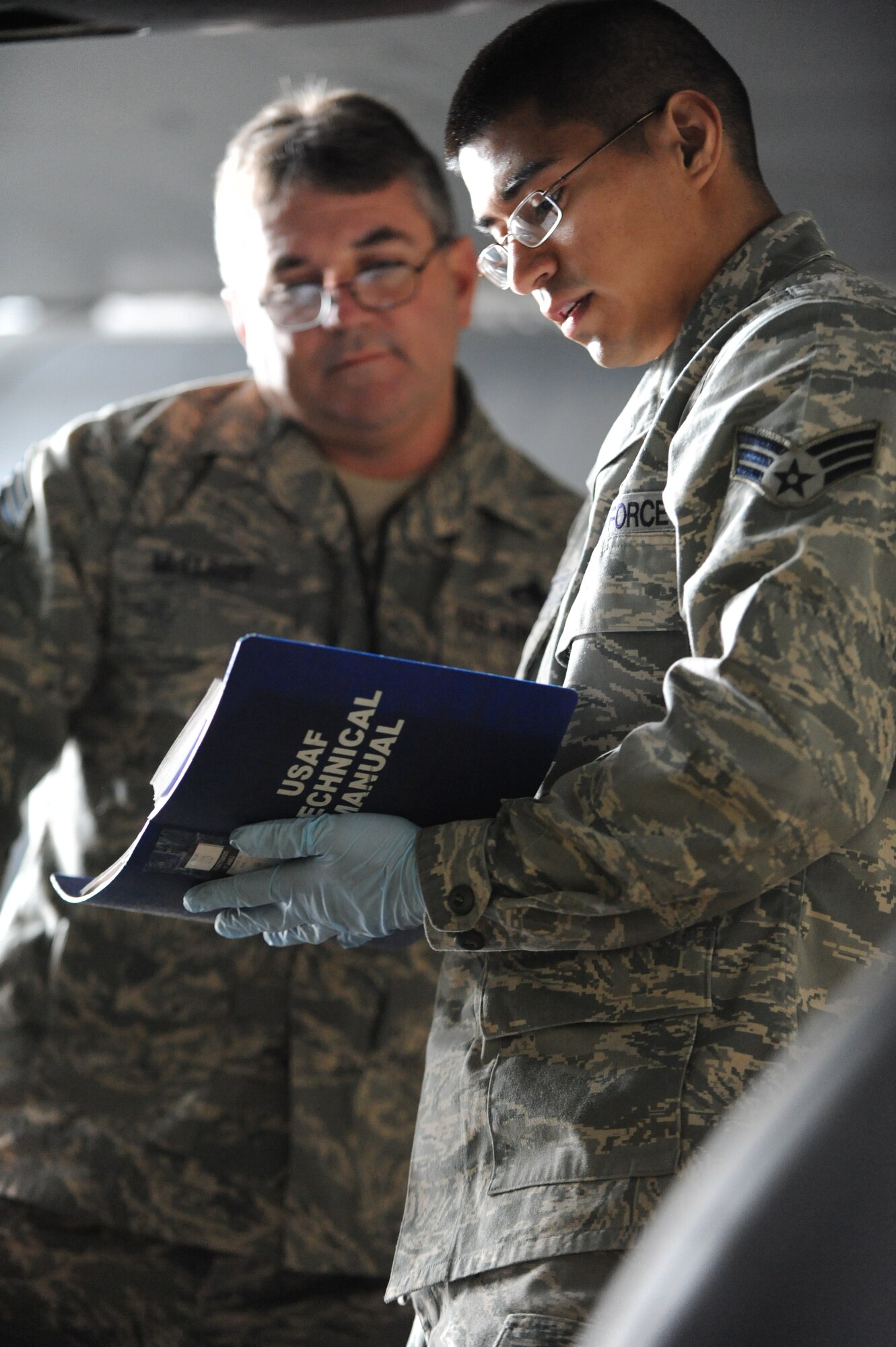 (Right) Senior Airman Tomas Loyde, 28th Aircraft Maintenance Squadron crew chief, goes through his technical order with Chief Master Sgt. Donald McElroy, Eighth Air Force evaluator team chief, during the 2009 bomb load competition preflight inspection, Feb. 12. Ellsworth, Barksdale AFB, La., Minot AFB, N. D., Whiteman AFB, Mo., and Dyess AFB, Texas, were all inspected by Eighth Air Force during the competition. (U.S. Air Force photo/Senior Airman Anthony Sanchelli)
