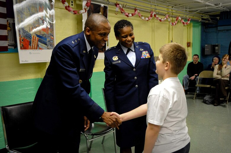 Maj. Gen. Darren W. McDew and Brig. Gen. Allyson Solomon shake the hand of a Public School 34 student who thanked the generals for speaking during their Citizenship Day assembly Feb. 11. General McDew is the director of Public Affairs, Office of the Secretary of the Air Force. General Solomon is the assistant adjutant general for the Maryland Air National Guard and special assistant to the National Guard Bureau chief. (U.S. Air Force photo/Lisa Stern)