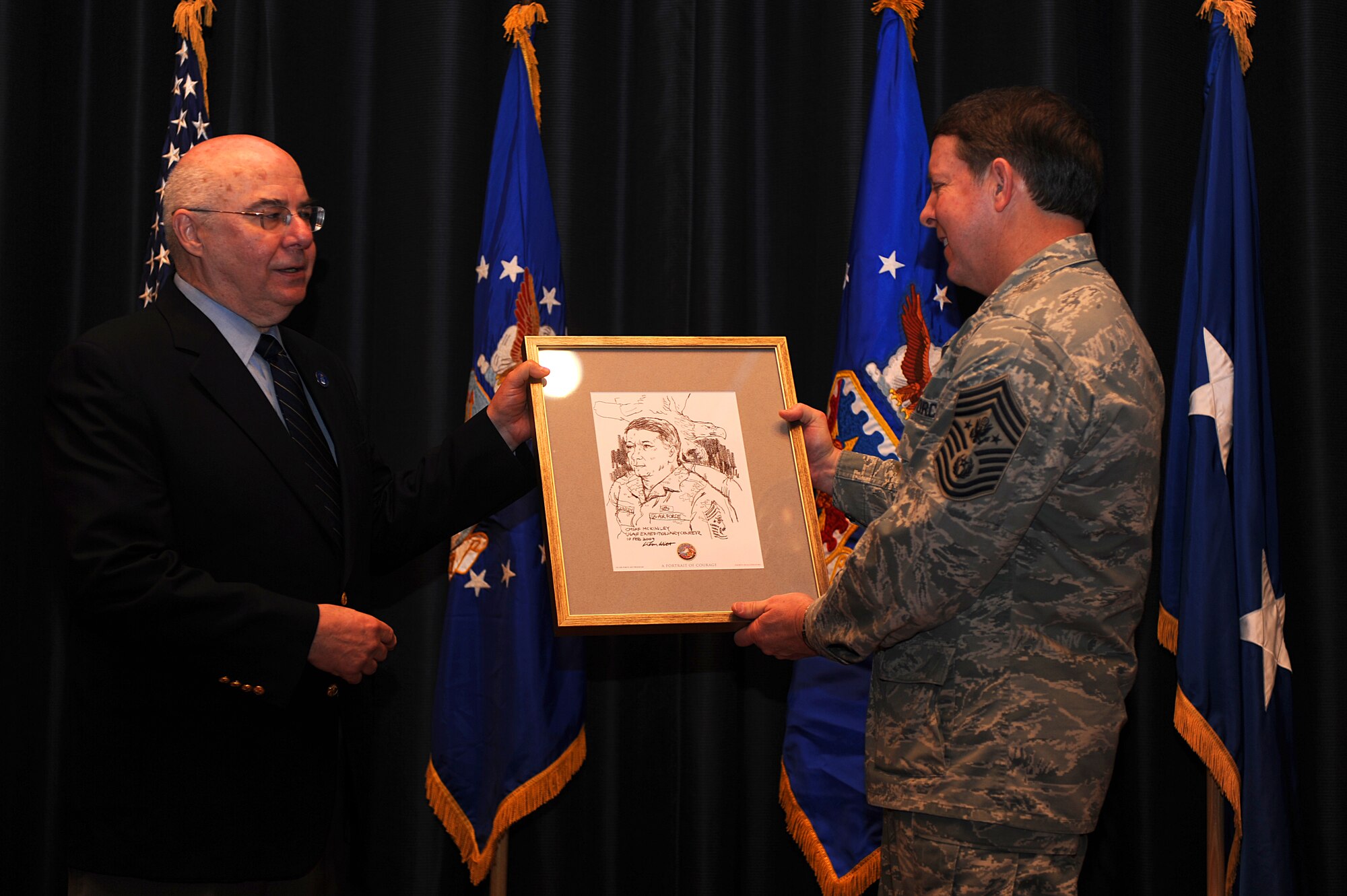 Artist John Witt, chairman of the New York Society of Illustrators, presents a sketch to Chief Master Sgt. of the Air Force Rodney McKinley on Feb. 10, 2009, during an enlisted call at Fort Dix, N.J.  Mr. Witt completed the sketch of Chief McKinley during an interview held earlier in the morning.  Chief McKinley visited McGuire and the U.S. Air Force Expeditionary Center on Fort Dix to learn more about expeditionary training and operations in both areas.  (U.S. Air Force Photo/Staff Sgt. Nathan Bevier)