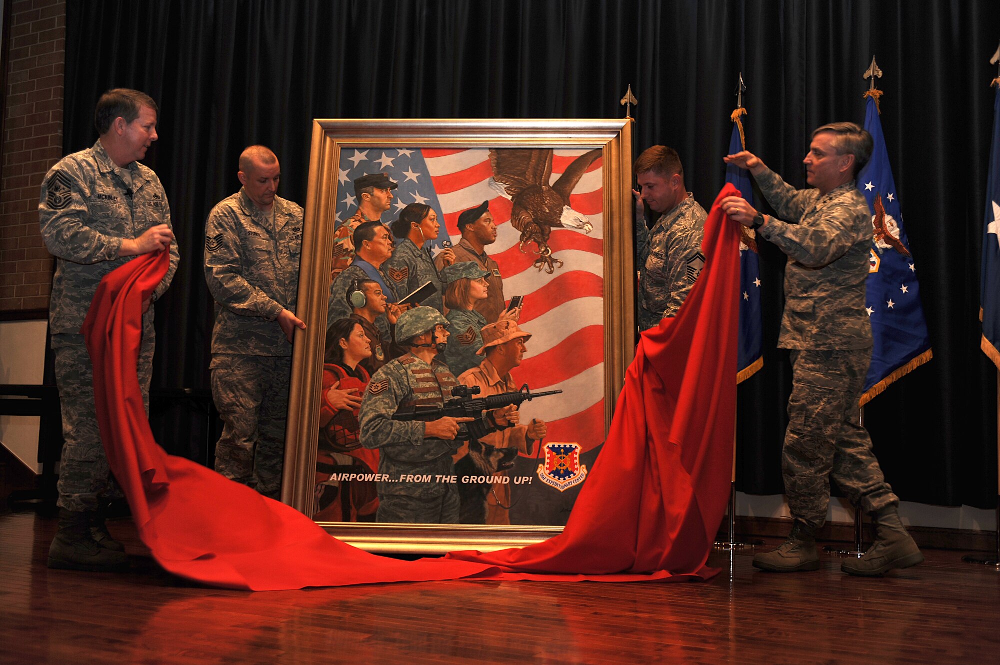 Chief Master Sgt. of the Air Force Rodney McKinley and Major Gen. Kip Self, U.S. Air Force Expeditionary Center commander, unveil a painting on Feb. 10, 2009, highlighting Expeditionary Center Airmen during an enlisted call at Fort Dix, N.J.  The painting, completed as part of the Air Force Art Program, was by Artist John Witt, chairman of the New York Society of Illustrators.  Chief McKinley visited McGuire and the Expeditionary Center on Fort Dix to learn more about expeditionary training and operations in both areas.  (U.S. Air Force Photo/Staff Sgt. Nathan Bevier)