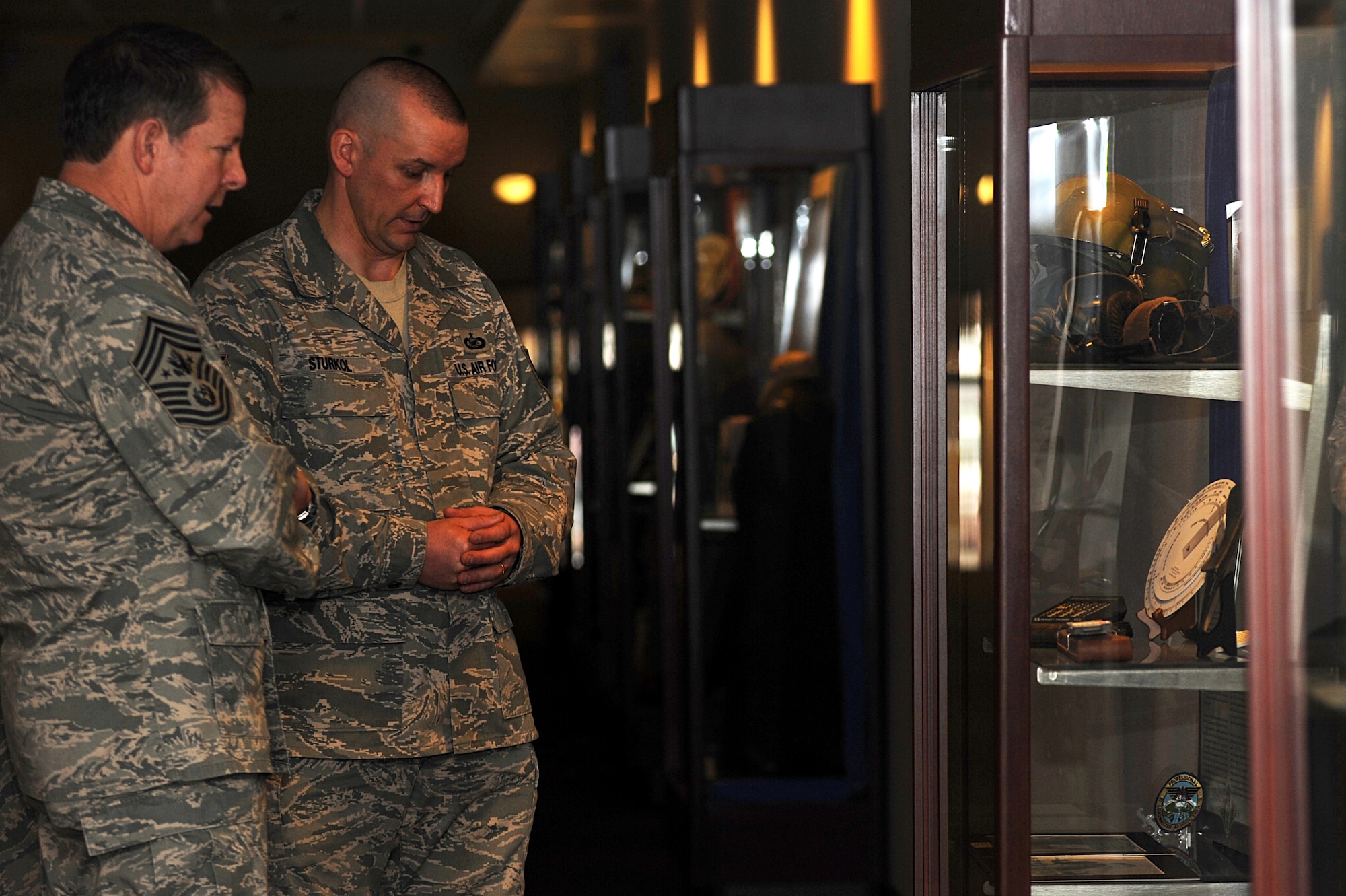 Tech. Sgt. Scott Sturkol, NCO in charge of Public Affairs, gives a tour to Chief Master Sgt. of the Air Force Rodney McKinley describing numerous items from different organizations within the U.S. Air Force Expeditionary Center's history cases on Fort Dix, N.J.  Chief McKinley visited McGuire Air Force Base and the Expeditionary Center to learn more about expeditionary training and operations in both areas.  (U.S. Air Force Photo/Staff Sgt. Nathan Bevier)