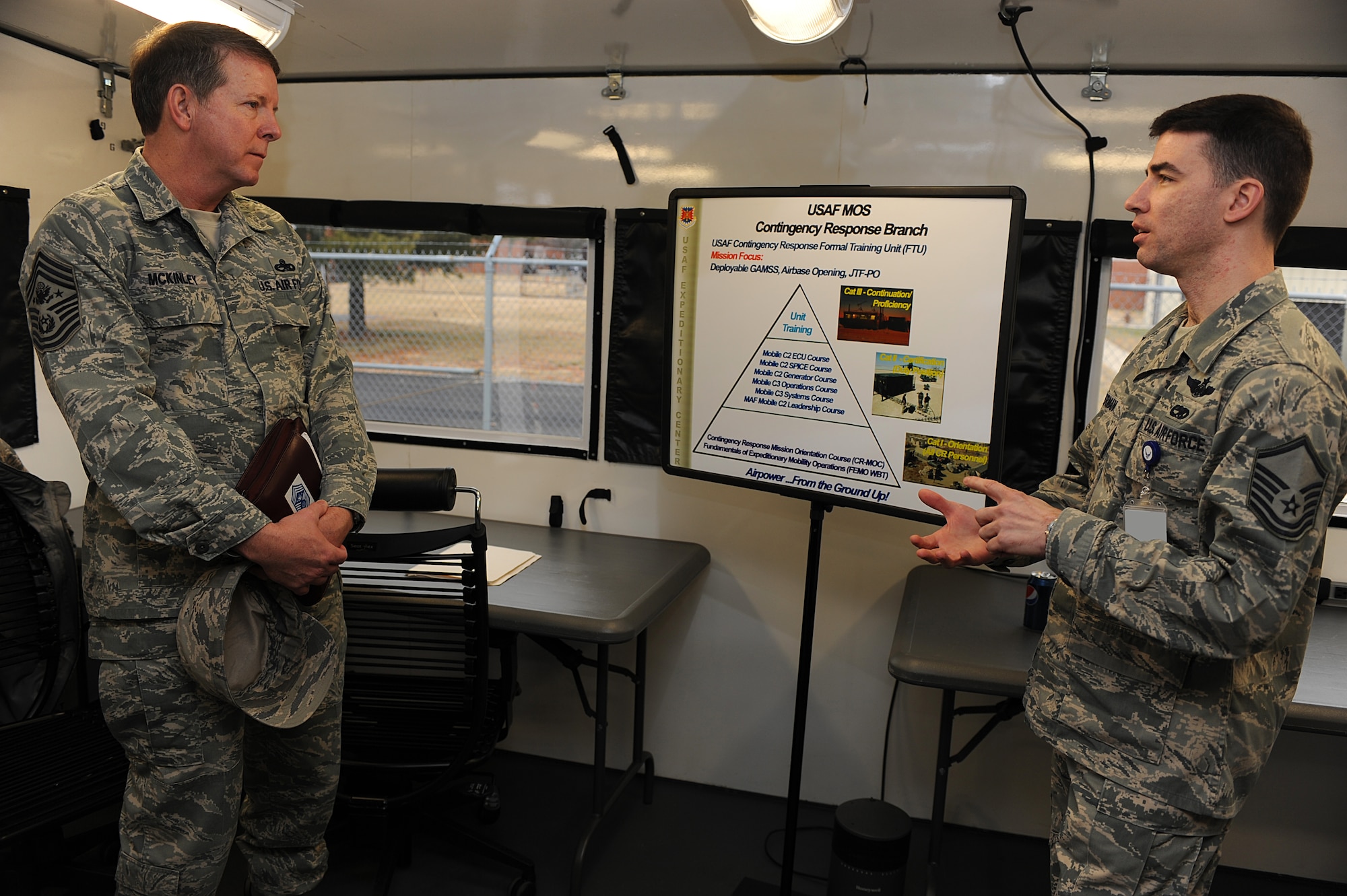 Master Sgt. Charles Sherman, course director for the Mobility Operations School's Mobility Air Forces Mobile Command and Control Leadership Course, briefs Chief Master Sgt. Rodney McKinley on Feb. 10, 2009, about the capabilities of the Hard-sided Expandable Lightweight Air Mobile Shelter, or HELAMS, in MOS’ Mobile C3 training facility on Fort Dix, N.J.  Chief McKinley visited McGuire Air Force Base and the U.S. Air Force Expeditionary Center on Fort Dix to learn more about expeditionary training and operations in both areas.  (U.S. Air Force Photo/Staff Sgt. Nathan Bevier)