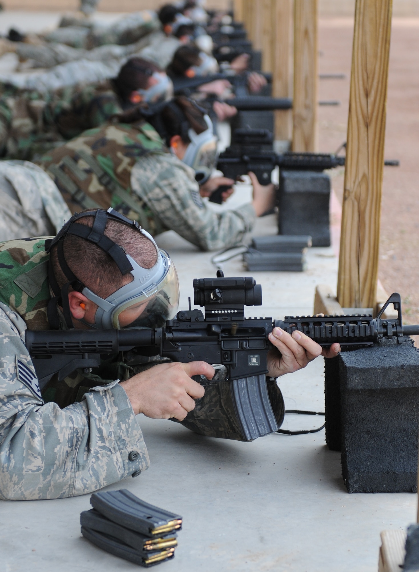 Airmen fire at the Combat Arms Training and Mainenance (CATM) range at Holloman Air Force Base, N.M., Jan. 22. The training that Airmen recieve at Holloman's CATM ensures everyone is capable and confident with handling their weapon. (U.S. Air Force photo/Senior Airman Michael Means) 
