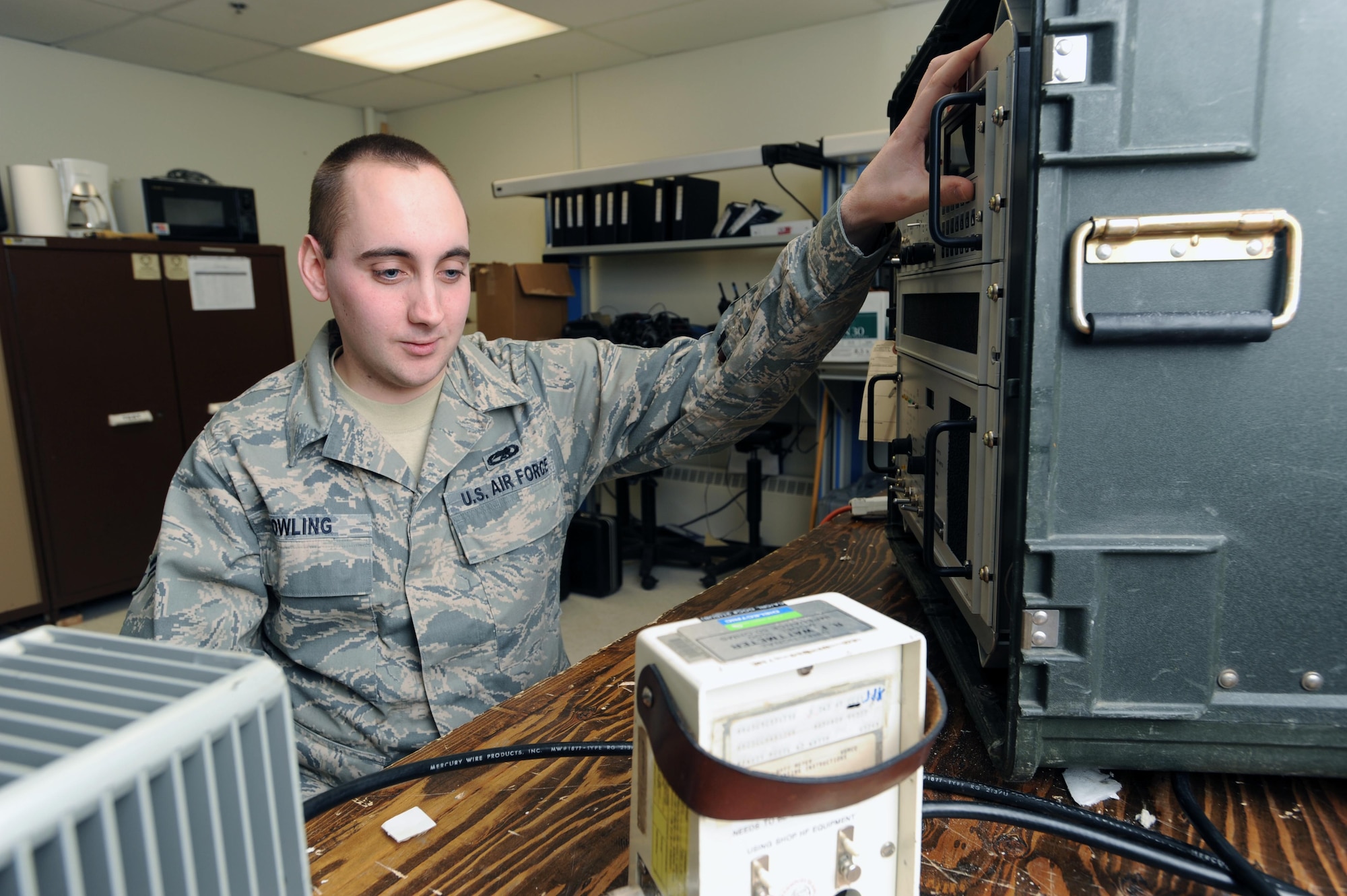 Airman 1st Class William Dowling, 319th Communication Squadron, monitors a watt meter to perform a preventative maintenance inspection on a URC 119 Radio. Airman Dowling shares his first-hand account of second-mile leadership as a young airman who has been affected by the leadership style. (U.S. Air Force photo/Tech. Sgt. Johnny Saldivar)