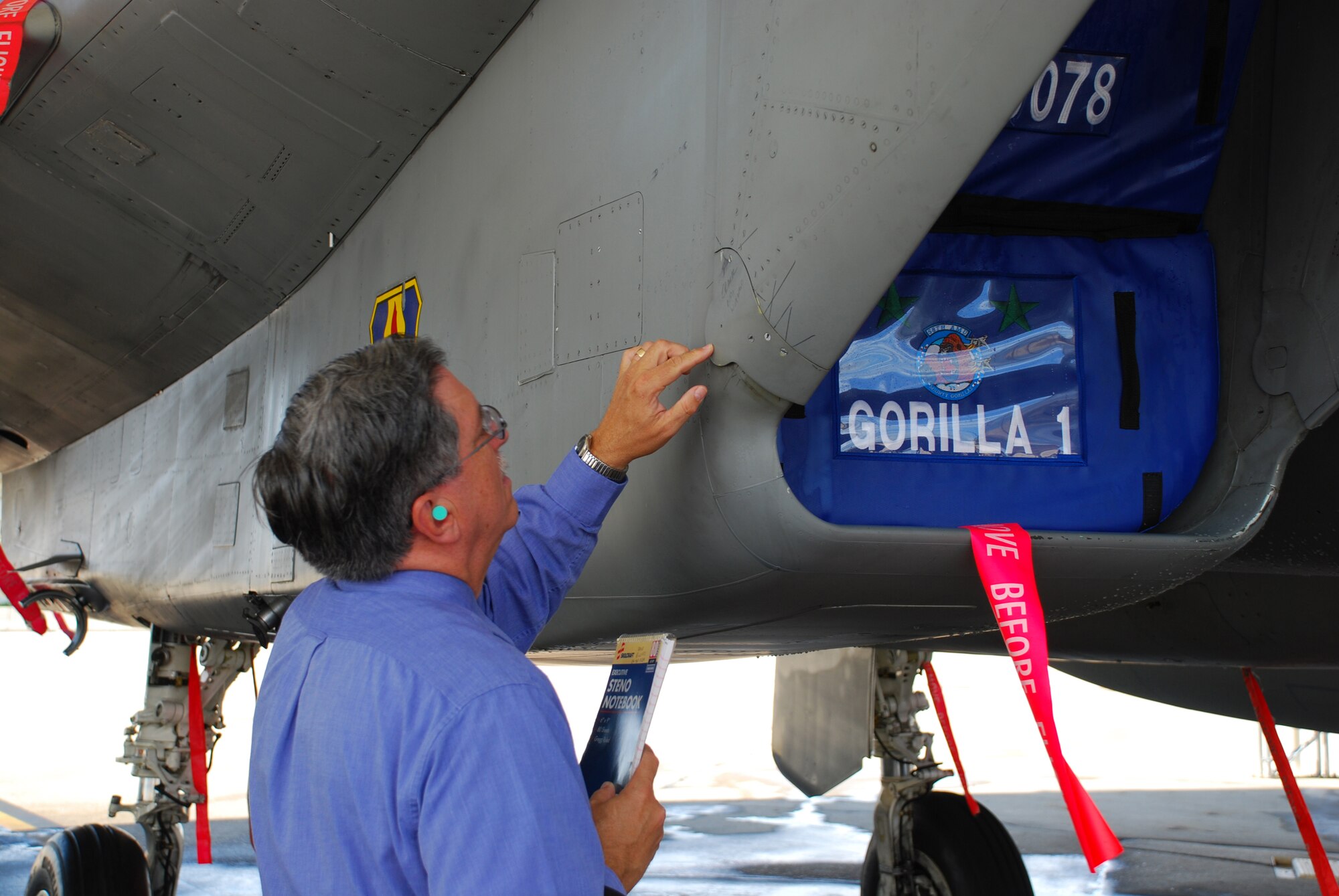 David Ellicks of the Air Force Corrosion Prevention and Control Office at Robins Air Force Base, Ga., inspects the intake area of an F-15 Eagle at Eglin AFB, Fla.  Specialists from the corrosion control office play a big role in keeping aircraft and ground equipment operating throughout the Air Force.  (Courtesy photo)