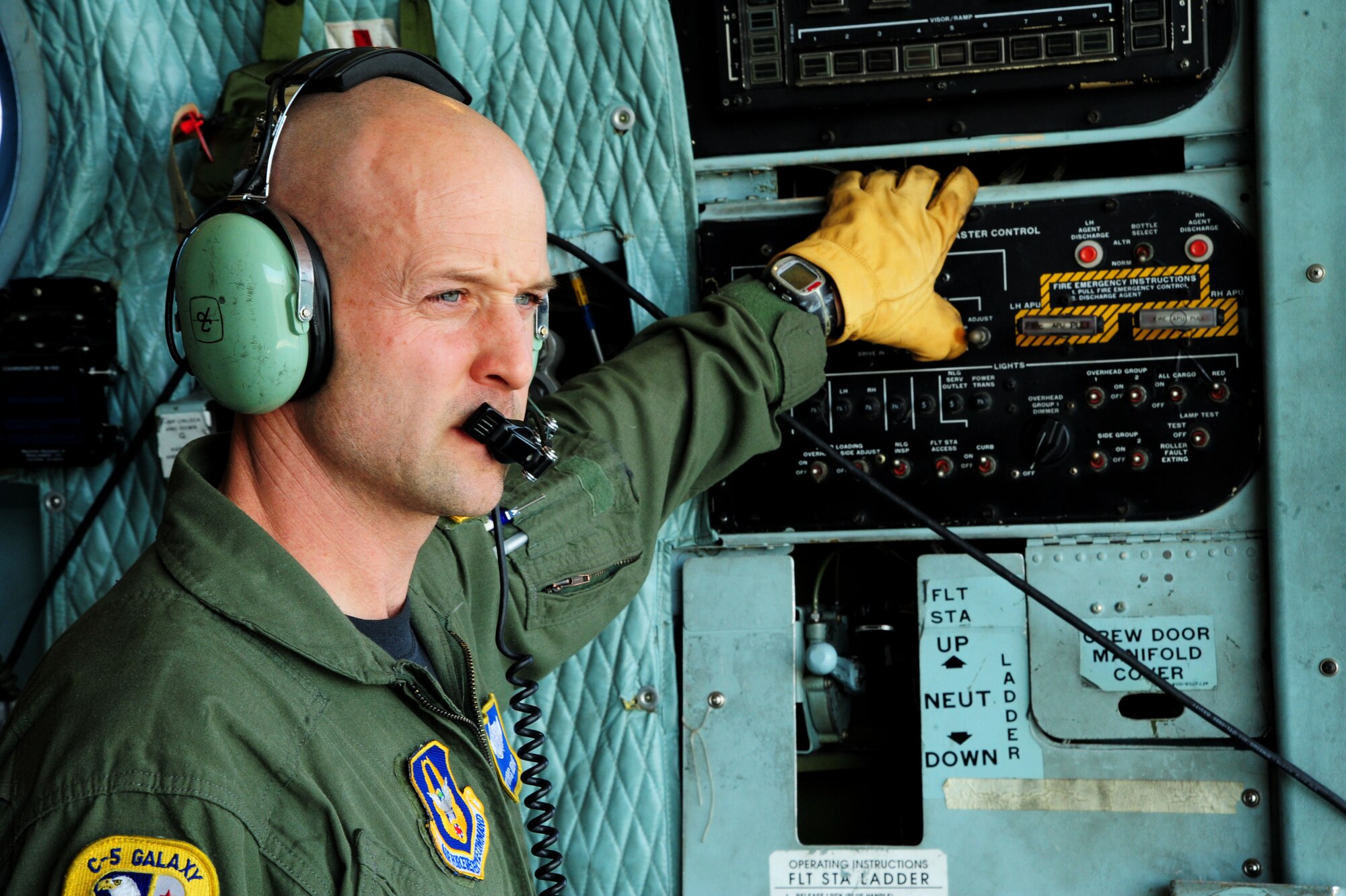 U.S. Air Force Master Sgt. Chris Hellyar lowers the ramp in order to load a U.S. Marine CH-53 helicopter onto a C-5 galaxy here on Camp Lemonier, Djibouti, Jan. 29, 2009. The helicopter was assigned to Combined Joint Task Force-Horn of Africa and was supporting Search and Rescue missions and Medical Civil Action Programs here in the Horn of Africa. The Marines were deployed from Marine Corps Station New River, NC, and the Air Force C-5 and crew were from Westover Air Reserve Base, MA.

(U.S. Air Force Photo by Staff Sgt. Joseph L. Swafford Jr.)

