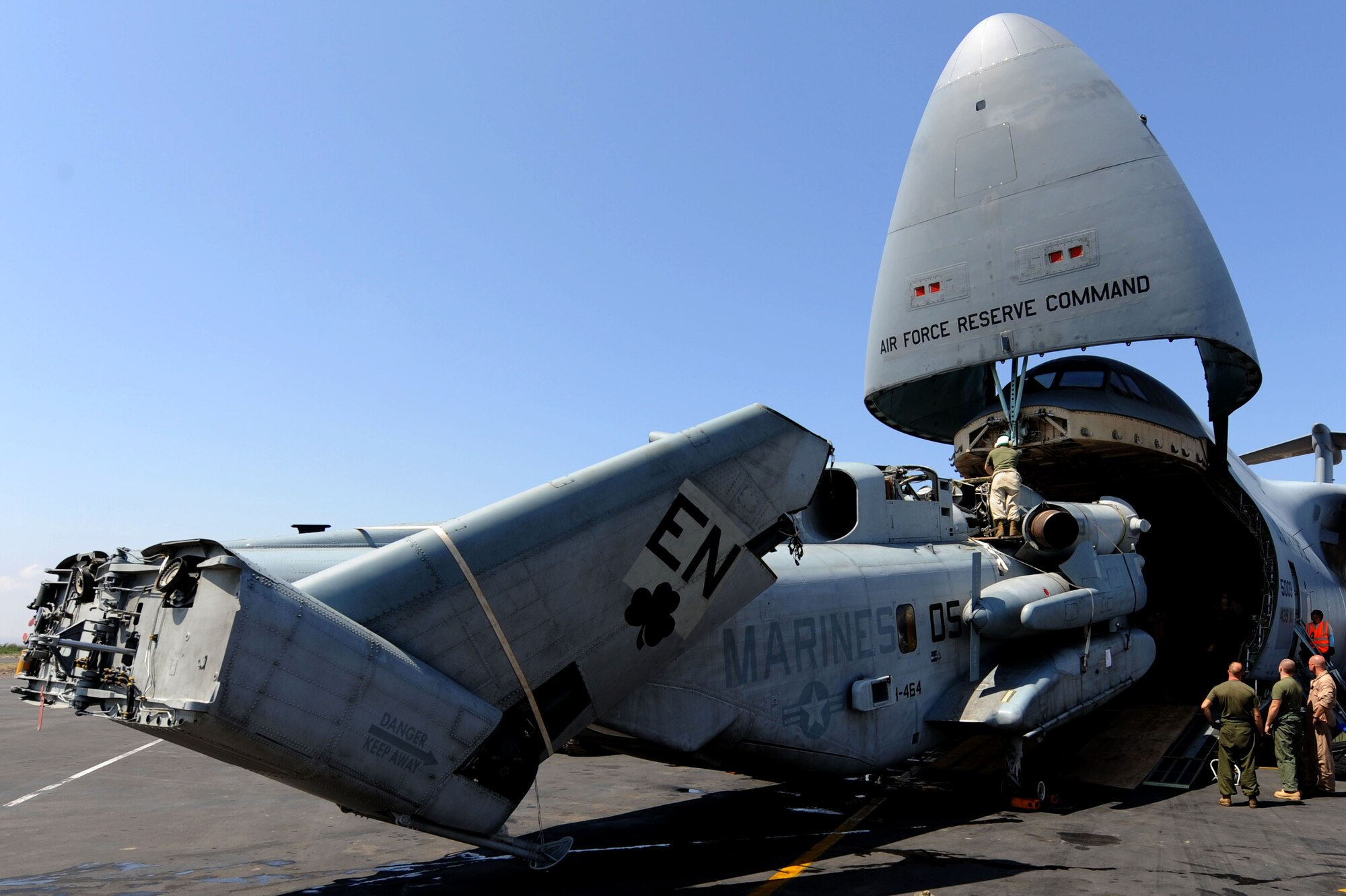 U.S. Marines load a CH-53 helicopter onto a U.S. Air Force C-5 here on Camp Lemonier, Djibouti, Jan. 29, 2009. The helicopter was assigned to Combined Joint Task Force-Horn of Africa and was supporting Search and Rescue missions and Medical Civil Action Programs here in the Horn of Africa. The Marines were deployed from Marine Corps Station New River, NC, and the Air Force C-5 and crew were from Westover Air Reserve Base, MA.

(U.S. Air Force Photo by Staff Sgt. Joseph L. Swafford Jr.)

