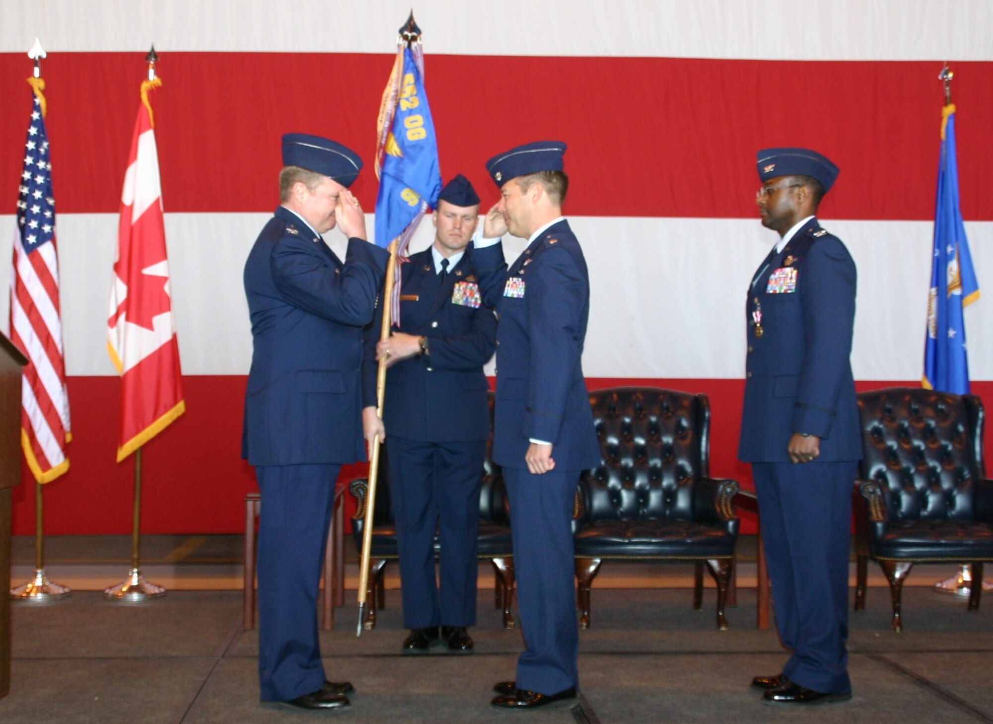 Col. George Carpenter, commander, 552nd Operations Group, salutes Lieutenant Col. Paul Oldham, the new commander of the 960th Airborne Air Control Squadron Vikings, in a ceremony February 12.