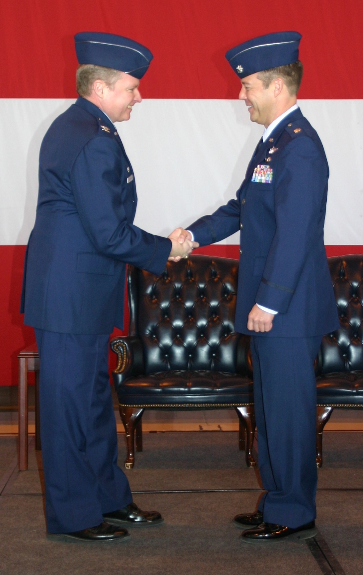 Col. George Carpenter, commander, 552nd Operations Group congratulates the new commander of the 960th Airborne Air Control Squadron Vikings, Lieutenant Col. Paul Oldham, during a change of command ceremony February 12.