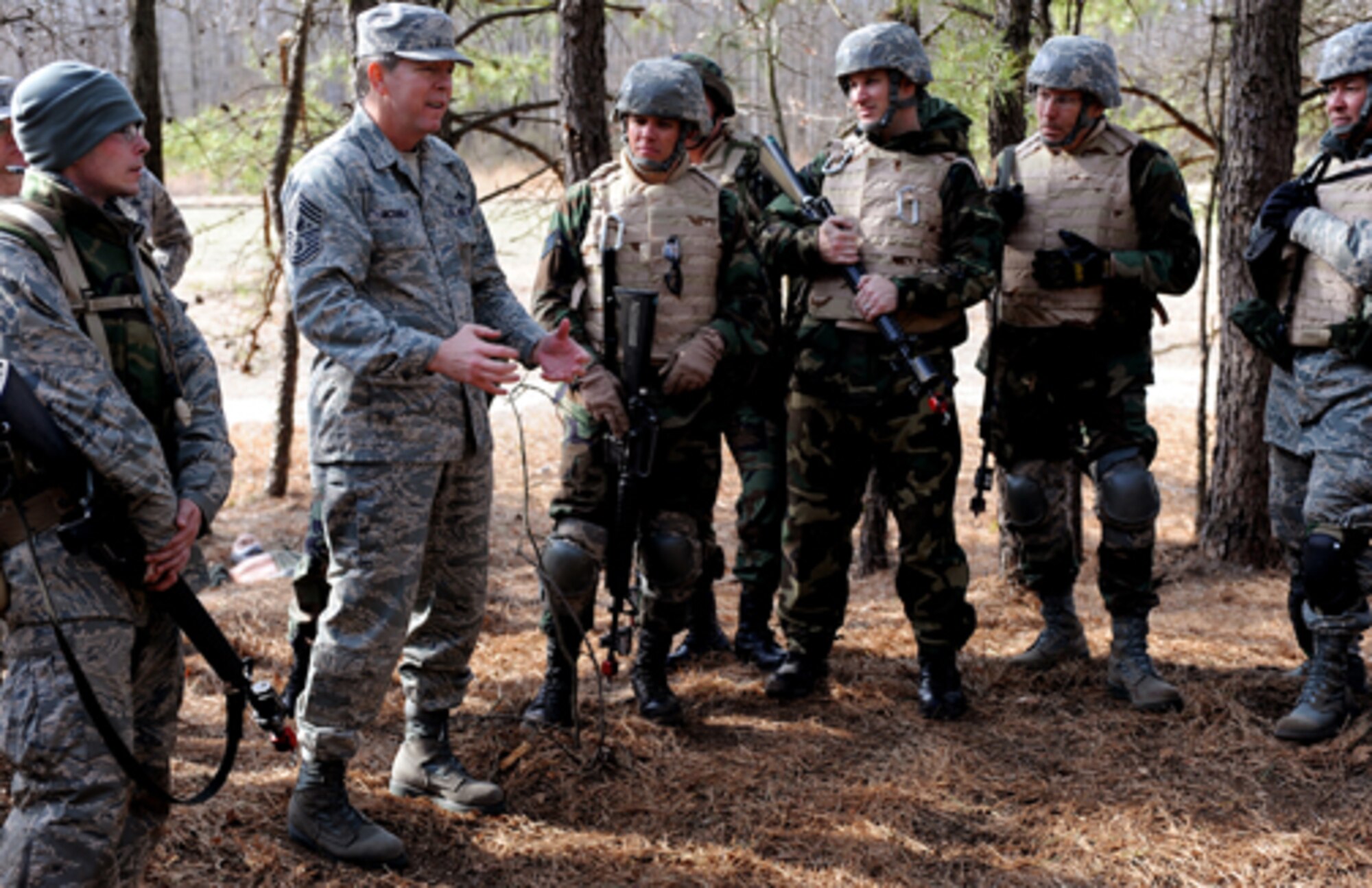 Chief Master Sergeant of the Air Force Rodney McKinley speaks with Airmen in the
Advanced Contingency Skills Training Course during a tour of combat first
aid/mounted on a range at Fort Dix Feb. 10. Chief McKinley visited McGuire and the U.S. Air Force Expeditionary Center at Fort Dix to learn more about expeditionary training and operations in both areas. (U.S. Air Force photo/Staff Sgt. Nathan Bevier)