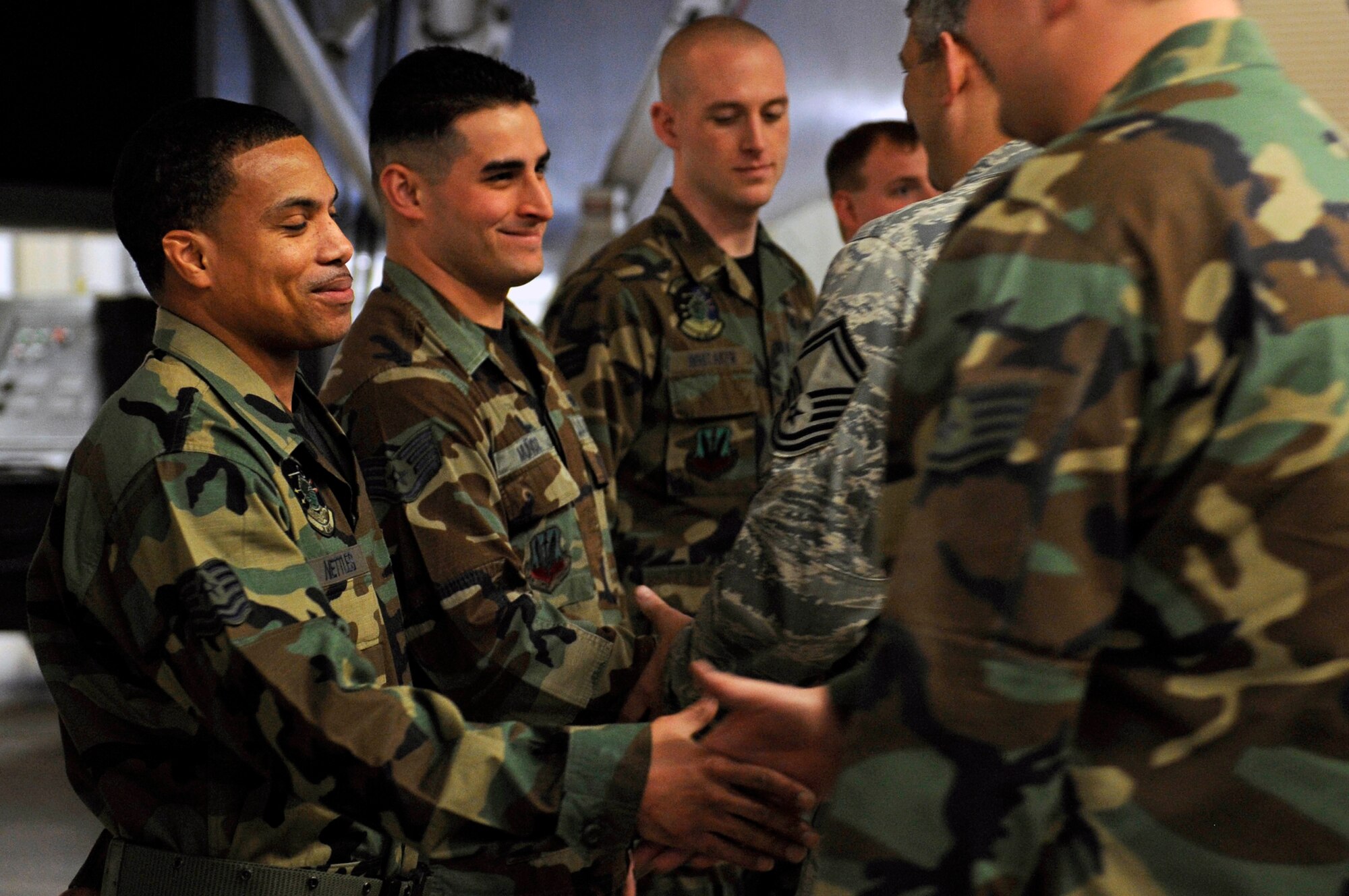 A team of load crew members from the 28th Aircraft Maintenance Squadron are congratulated by a line of Ellsworth members in the 2009 bomb load competition here, Feb. 12. The competition features the best load crews from five bomber bases and is scored and rated by evaluators from Eighth Air Force. (US Air Force photo/Airman 1st Class Corey Hook)