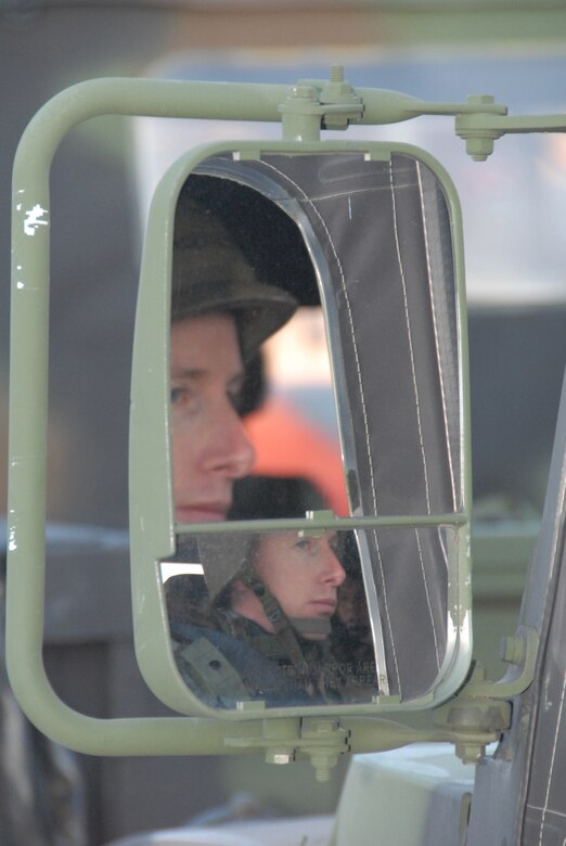 Reflected in the mirror of his High-Mobility Multipurpose Wheeled Vehicle (HUMVEE), Master Sgt. David Anderson waits for the signal to move out with the rest of a 442nd Civil Engineer Squadron convoy during combat training Jan. 11, 2008.  The squadron is part of the 442nd Fighter Wing, an Air Force Reserve A-10 unit based at Whiteman Air Force Base, Mo.  (U.S. Air Force photo/Staff Sgt. Tom Talbert)