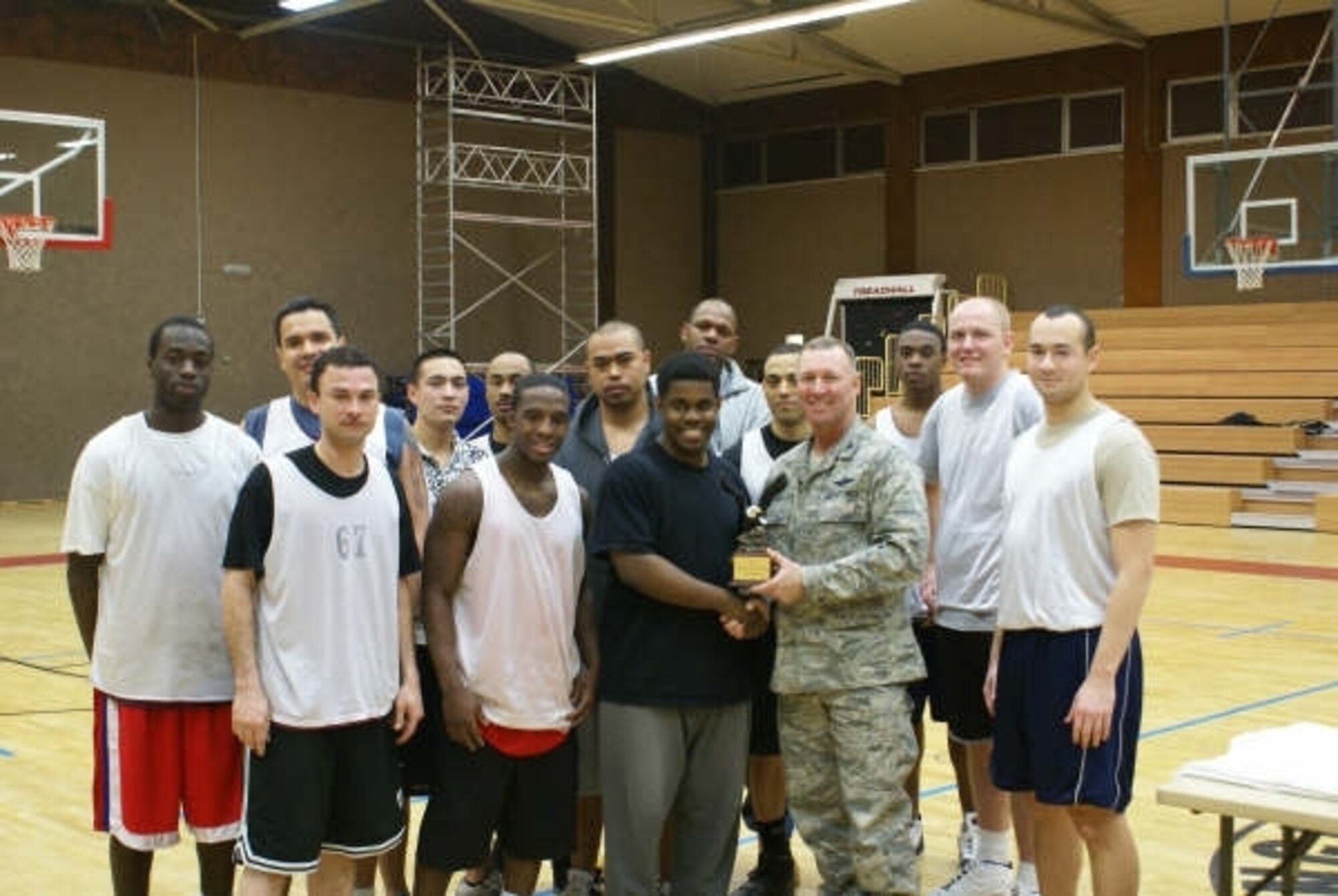 SPANGDAHLEM AIR BASE, Germany -- Col. Lee T. Wright, 52nd Fighter Wing commander, presents the 2008-2009 Intramural Championship trophy to the 52nd C.S. team Jan. 29, 2009. (U.S. Air Force photo by Mark Geairn)