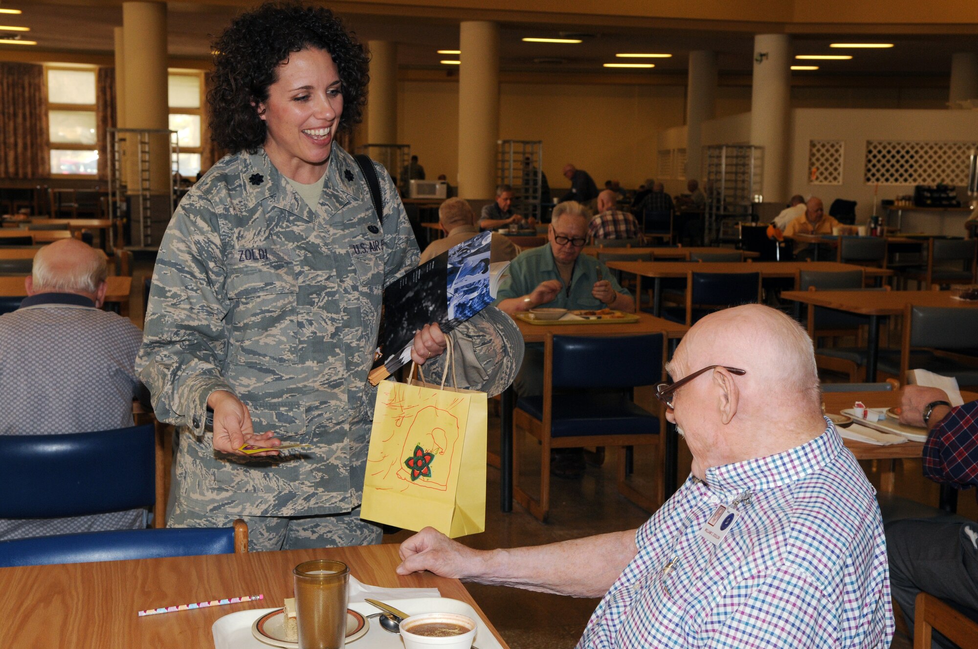 Lt. Col. Dawn Zoldi, 11th Wing Staff Judge Advocate, hands out a Valentine’s Day card to William Doulon, Armed Forces Retirement Home resident, Feb. 12 in Washington. The JA office volunteers twice a year, during Valentine’s Day and Christmas, to visit with the veterans staying at the AFRH. For more information, call Sandra Meadows at (202) 767-5297. (U.S. Air Force Photo by Senior Airman Marleah Miller)