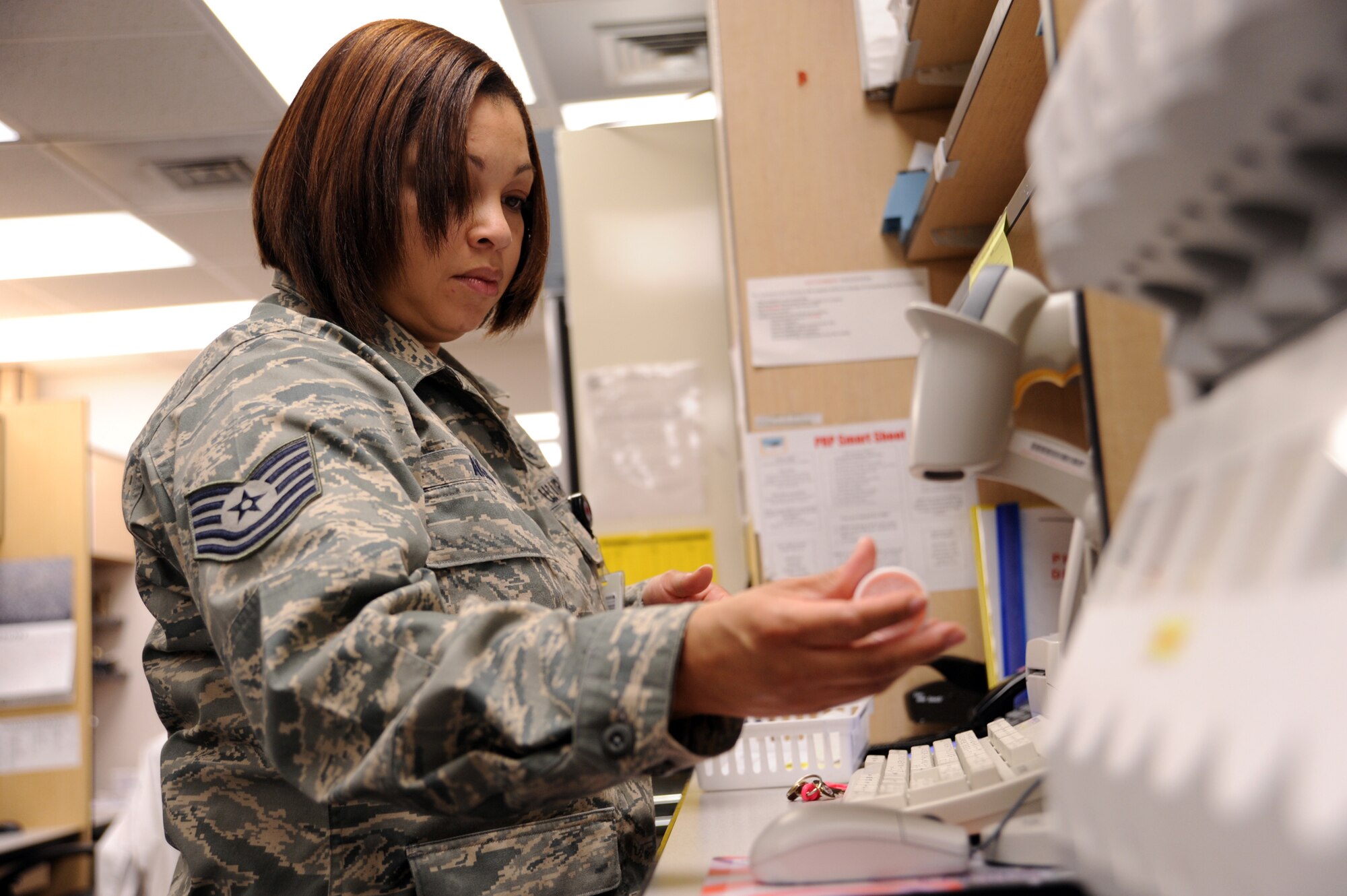 WHITEMAN AIR FORCE BASE, Mo. – Tech. Sgt. Knicole Akins, non-commissioned officer in-charge of pharmacy services, scans a prescription Feb 13. She earned Air Force Pharmacy NCO of the Year by launching a workload capture effort to convert age-old manual data input to new bar-code technology, saving hundreds of man-hours on over 122,000 records. (U.S. Air Force photo/Senior Airmen Stephen Linch)
