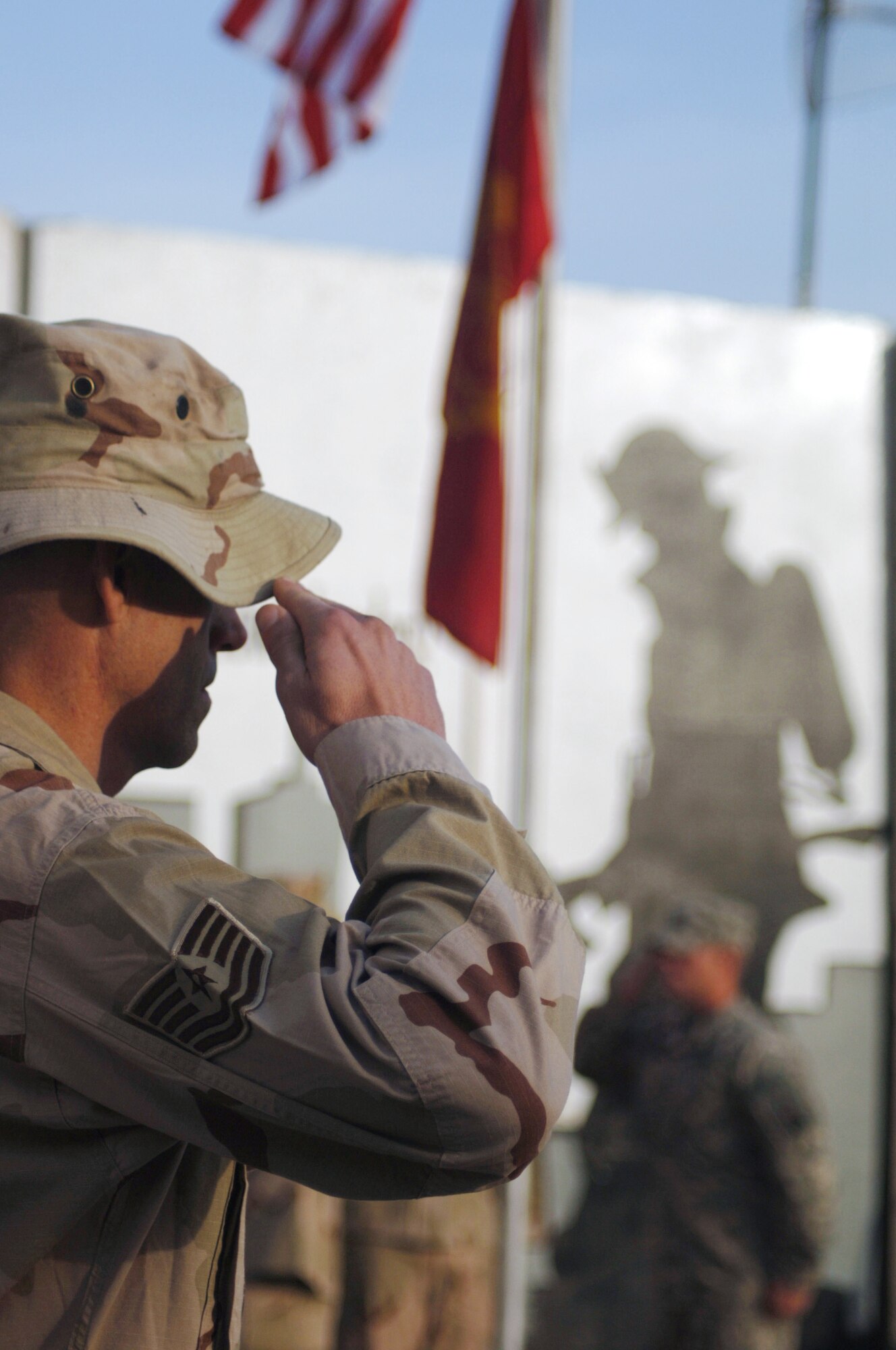 JOINT BASE BALAD, Iraq ? Tech. Sgt. Dwayne Jackson, 332nd Expeditionary Civil Engineer Squadron firefighter, salutes the U.S. flag during a memorial ceremony honoring fallen firefighter, Staff Sgt. Ray Rangel. Today marks the four-year anniversary of Rangel?s death. Rangel, a fire emergency services technician, died Feb. 13, 2005, while attempting to save two Soldiers trapped in an overturned humvee in a canal in northern Iraq. Jackson is currently deployed here from Dyess Air Force Base, Texas, and is a native Albuquerque, N.M. (U.S. Air Force photo/Staff Sgt. Dilia Ayala)