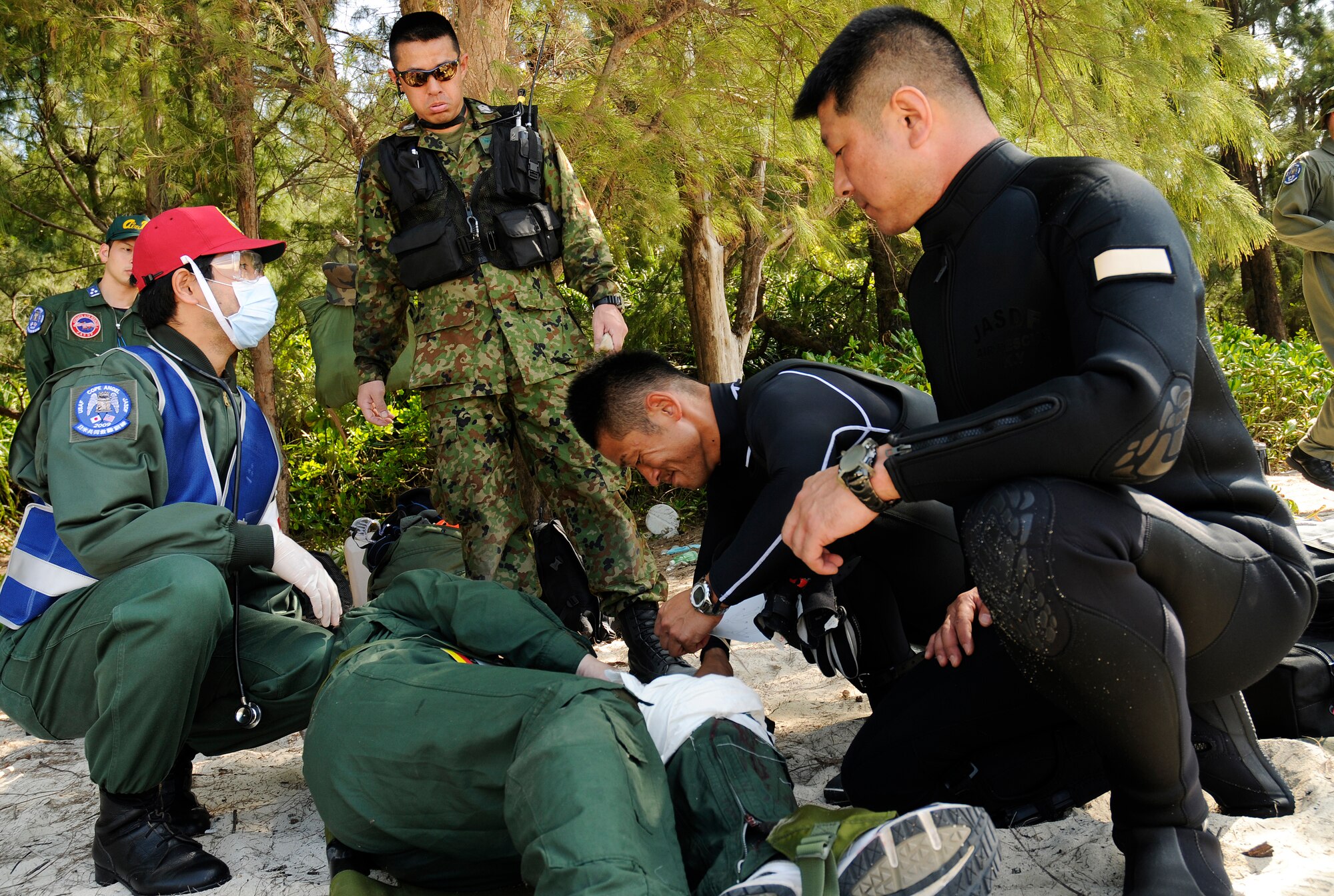 Japanese Air Self Defense Force (JASDF) Air Rescue personnel treat a simulated survivor on a beach off the coast of Okinawa, Japan during exercise Cope Angel 09-1, Feb. 12, 2009. Cope Angel is a joint rescue exercise between members of the U.S. Air Force and the JASDF. (U.S. Air Force photo/Airman 1st Class Chad Warren)