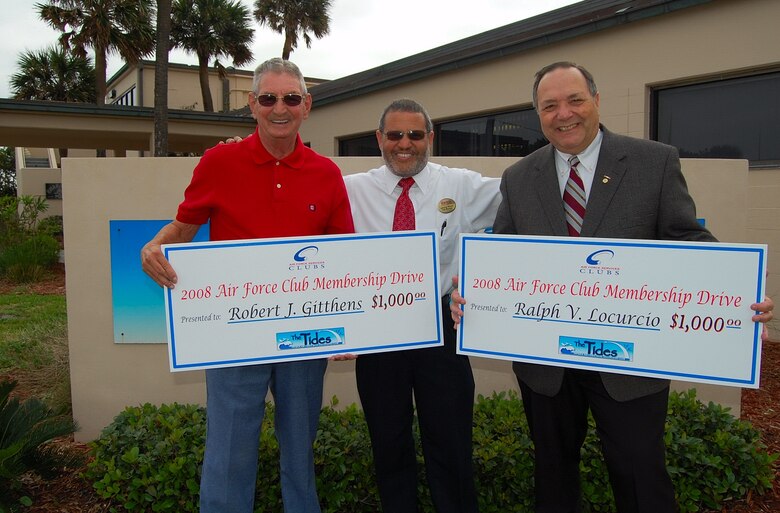 Robert Gitthens (left) and Ralph Locurcio (right) are all smiles after they each received a $1,000 check at The Tides recently by club manager, Johnnie Rivera. Both men took part in an online survey during the 2008 AF Clubs Membership Drive, where 10 club members were randomly selected AF-wide to receive a cash award for their participation. (U.S. Air Force photo by Chris Kraus)