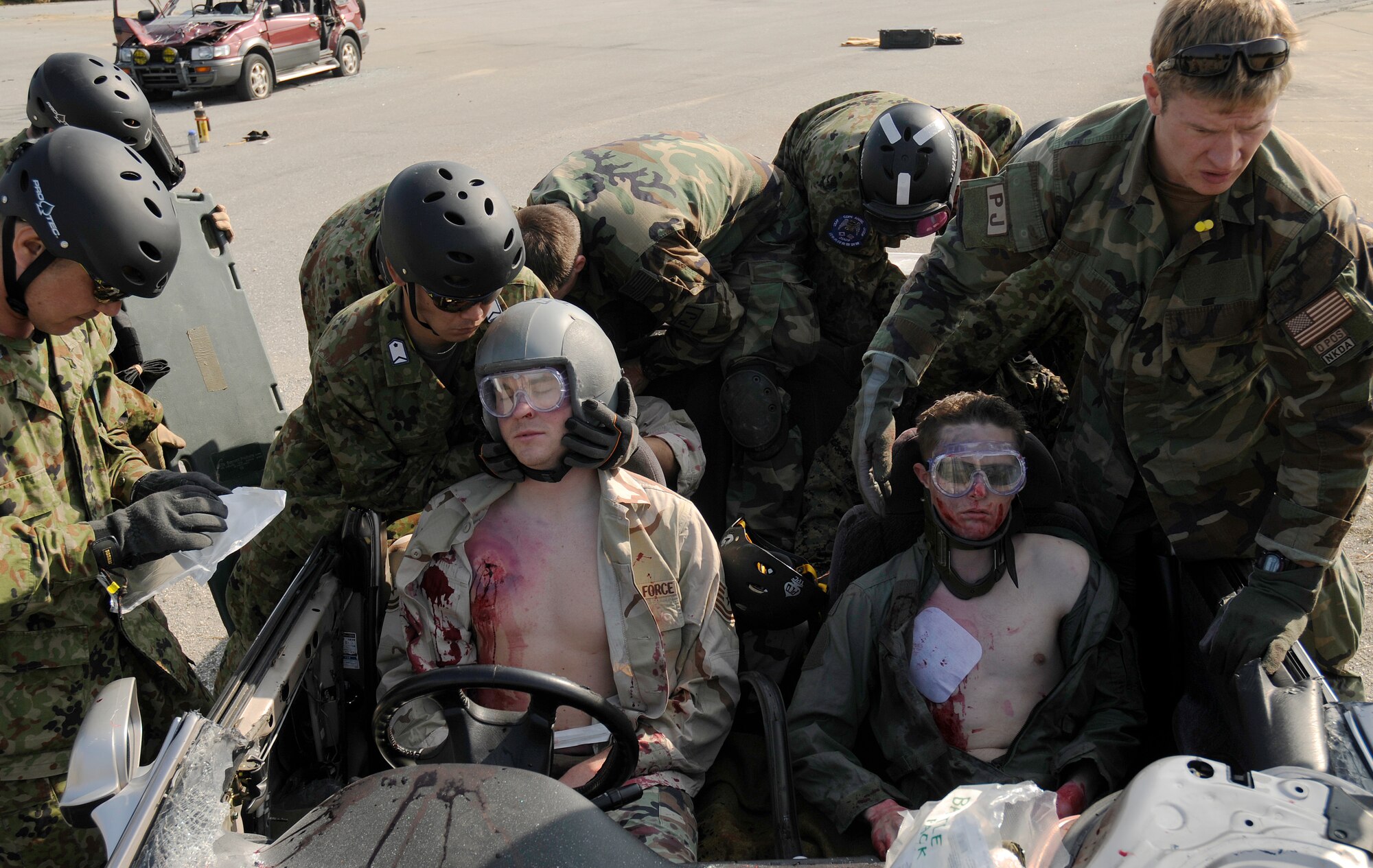 Air rescue personnel from the Japanese Air Self Defense Force (JASDF) along with pararescuemen from the 31st Rescue Squadron at Kadena Air Base, Japan treat simulated survivors as part of a training scenario during exercise Cope Angel 09-1, Feb. 11, 2009. Cope Angel is a joint rescue exercise between members of the U.S. Air Force and the JASDF. (U.S. Air Force photo/Airman 1st Class Chad Warren)