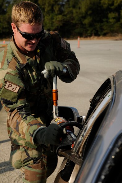 Senior Airman Williams, a pararescueman from the 31st Rescue Squadron, removes a car door with the jaws of life during exercise Cope Angel 09-1, Feb. 11, 2009. Cope Angel is a joint rescue exercise between members of the U.S. Air Force and the Japanese Air Self Defense Force. (U.S. Air Force photo/Airman 1st Class Chad Warren)