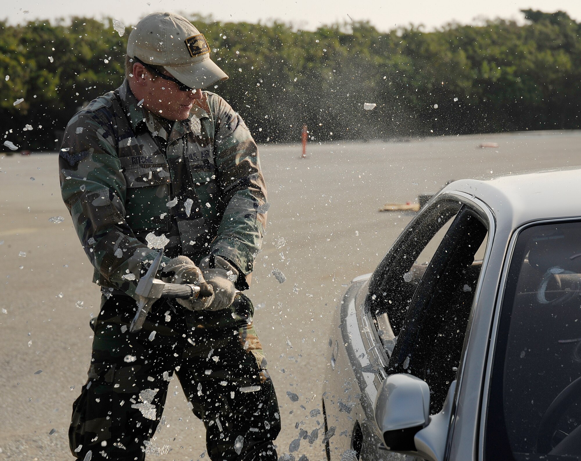 Senior Airman Ritchie, a pararescueman from the 31st Rescue Squadron, breaks a car window with a crash axe during exercise Cope Angel 09-1, Feb. 11, 2009. Cope Angel is a joint rescue exercise between members of the U.S. Air Force and the Japanese Air Self Defense Force. (U.S. Air Force photo/Airman 1st Class Chad Warren)