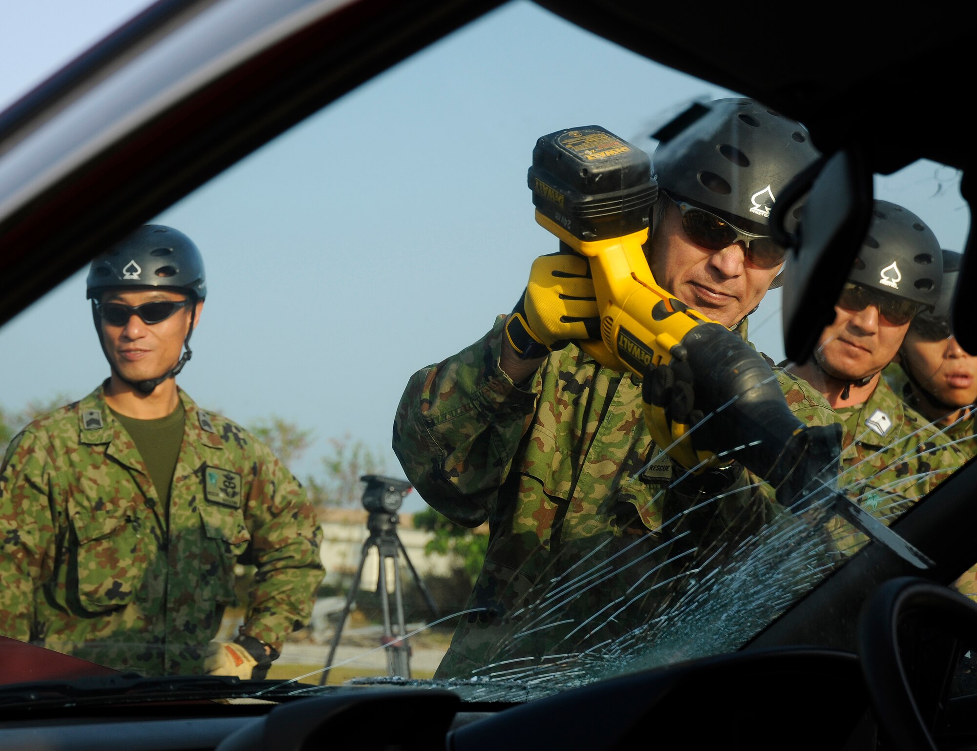 Air rescue personnel from the Japanese Air Self Defense Force (JASDF) use a reciprocating saw to remove a car windshield during exercise Cope Angel 09-1, Feb. 11, 2009. Cope Angel is a joint rescue exercise between members of the U.S. Air Force and the JASDF. (U.S. Air Force photo/Airman 1st Class Chad Warren)