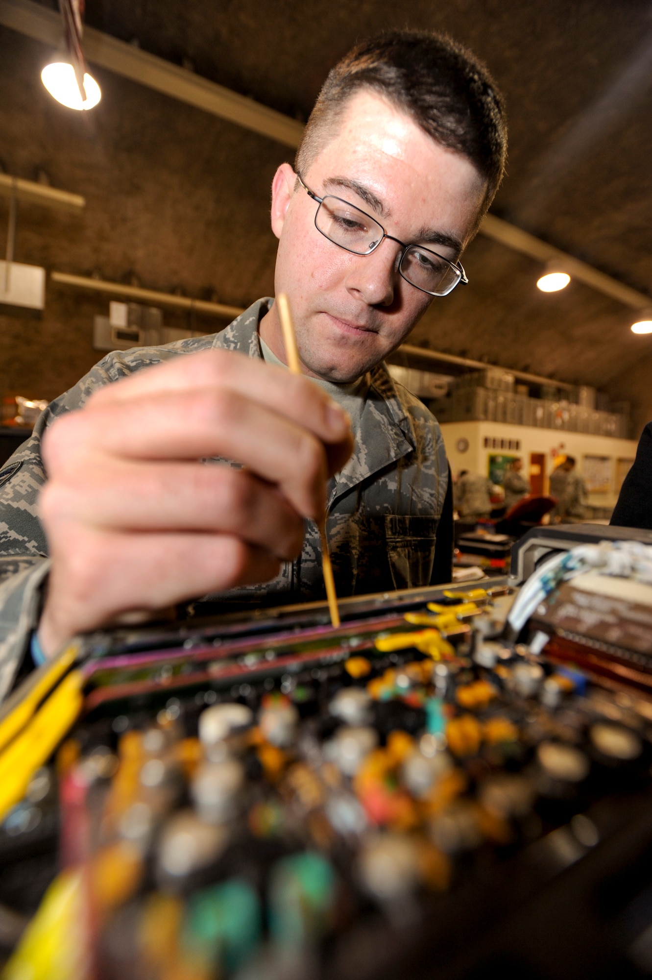 Airman 1st Class Chaz Bucholtz, an Avionics Intermediate Support technician with the 379th Expeditionary Maintenance Squadron, adjusts the x/y deflection of a Multi Purpose Display from an F-15E Strike Eagle, Feb. 11, 2009, in an undisclosed location in Southwest Asia.  Airman Bucholtz repairs various components of the F-15E's avionics system within the U.S. Central Command's area of responsibility. Airman Bucholtz is native to Dayton, Ohio and is deployed from Royal Air Force, Lakenheath, England in support of Operations Iraqi and Enduring Freedom and Combined Joint Task Force - Horn of Africa. (U.S. Air Force Photo by Staff Sgt. Joshua Garcia/released)