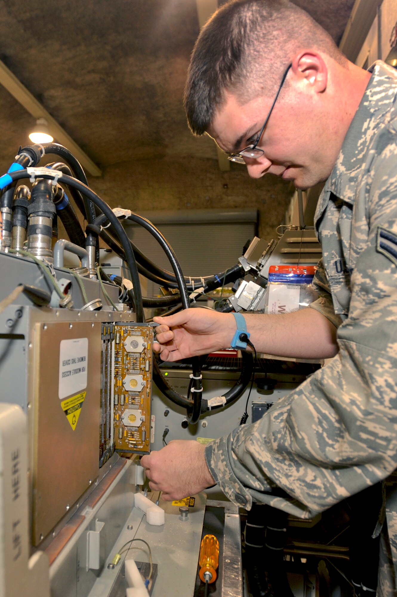 Airman 1st Class Chaz Bucholtz, an Avionics Intermediate Support technician with the 379th Expeditionary Maintenance Squadron, replaces an A9 board from an analog/digital converter off of an F-15 Eagle APG-70 radar, Feb. 11, 2009, in an undisclosed location in Southwest Asia.  The radar system reads the surroundings of the aircraft for navigational purposes and lets the F-15 pilot know the location of other aircraft are in the area.  Airman Bucholtz is native to Dayton, Ohio and is deployed from Royal Air Force, Lakenheath, England in support of Operations Iraqi and Enduring Freedom and Combined Joint Task Force - Horn of Africa. (U.S. Air Force Photo by Staff Sgt. Joshua Garcia/released)  