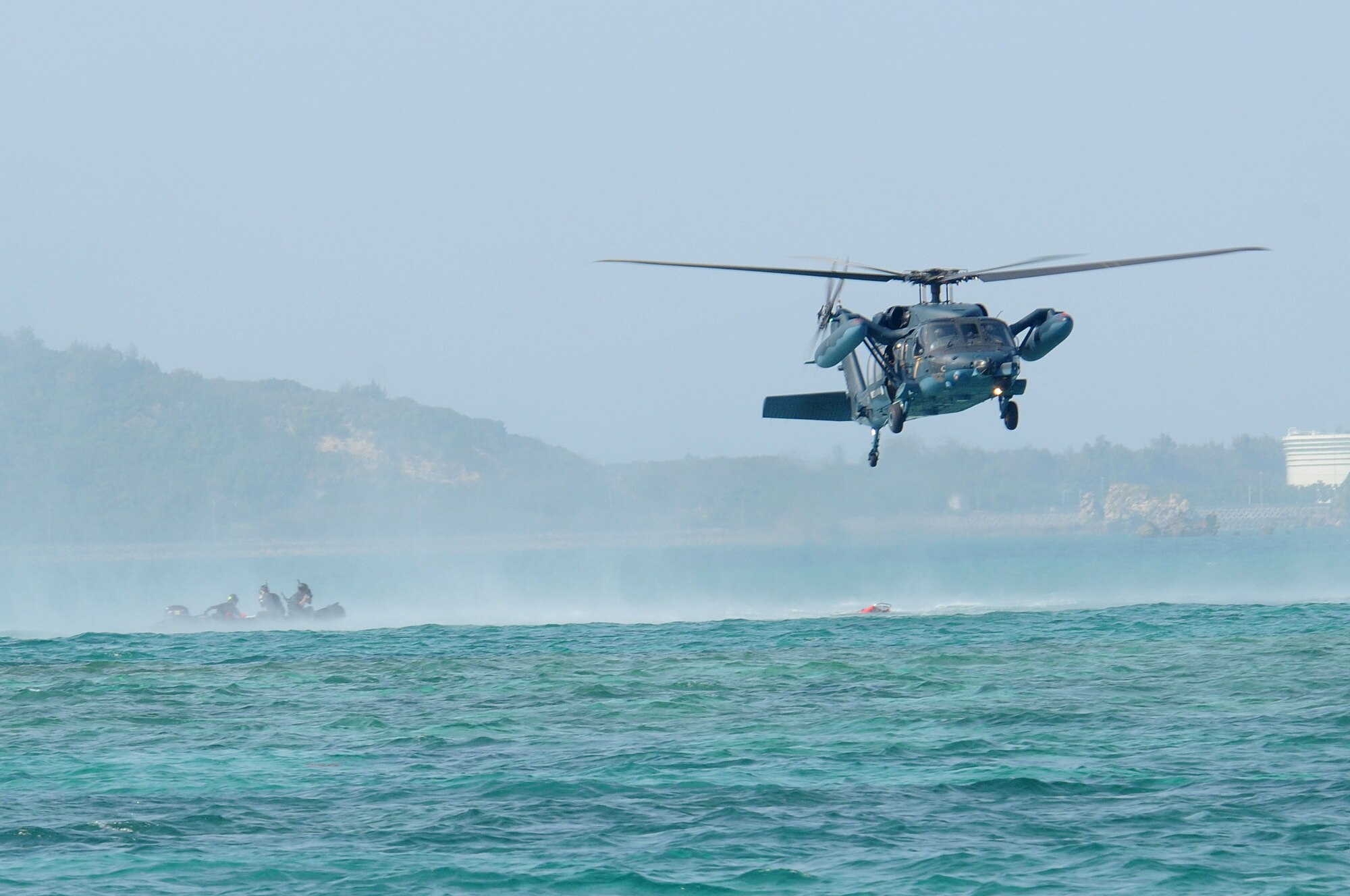 A JASAF UH-60 Black Hawk drops a liter to hoist up a victim to safety, during exercise Cope Angel 09-1, Feb. 12, 2009. Cope Angel is a joint rescue exercise between members of the U.S. Air Force and the Japanese Air Self Defense Force.  (U.S. Air Force photo/Staff Sgt Chrissy Best)