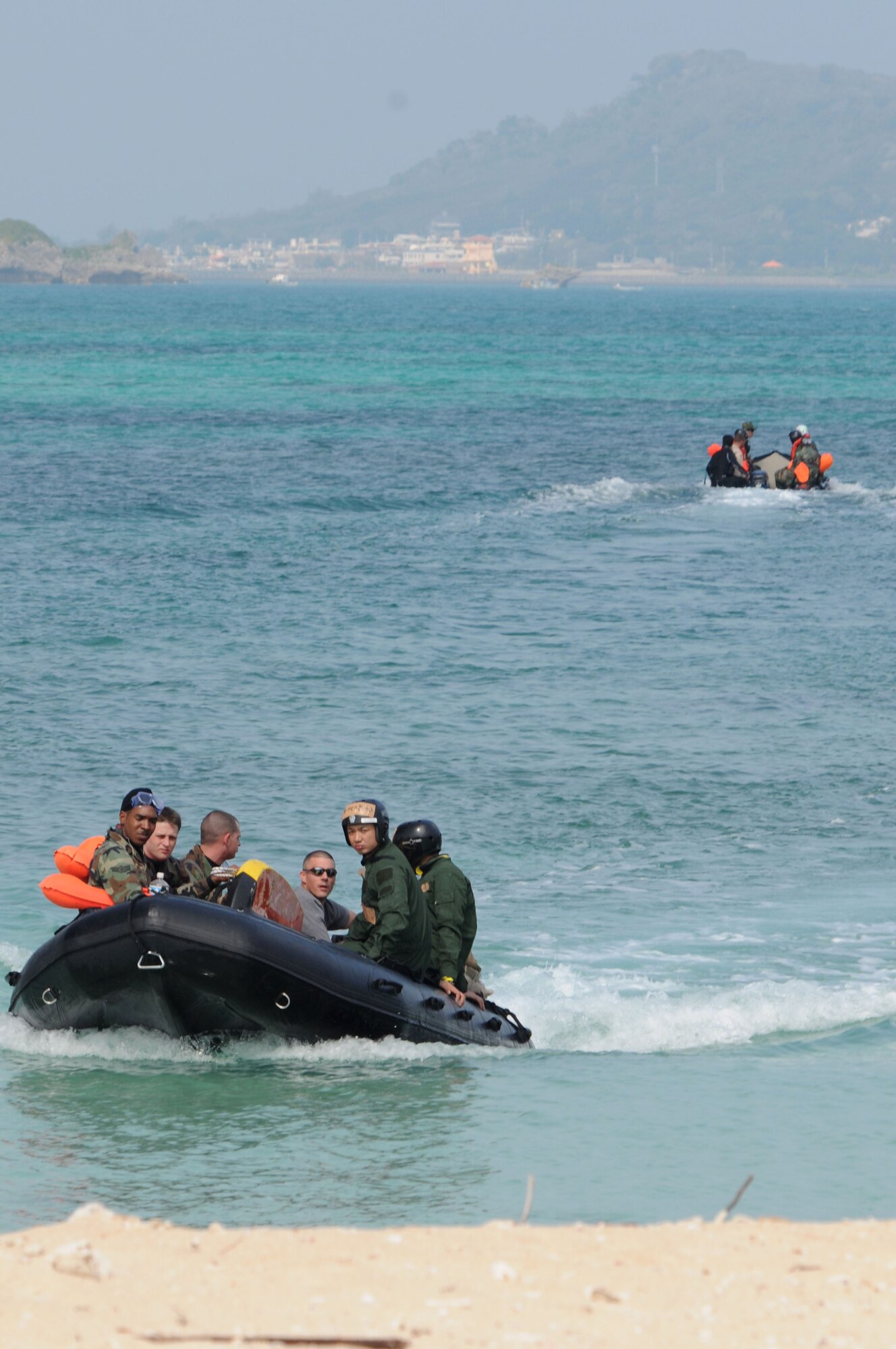Pararescuemen from the 31st Rescue Squadron at Kadena Air Base, Japan and JASAF pararescuemen, use Zodiacs to take simulated victims to their locations to wait to be rescued, during exercise Cope Angel 09-1, Feb. 12, 2009. Cope Angel is a joint rescue exercise between members of the U.S. Air Force and the Japanese Air Self Defense Force. (U.S. Air Force photo/Staff Sgt Chrissy Best)