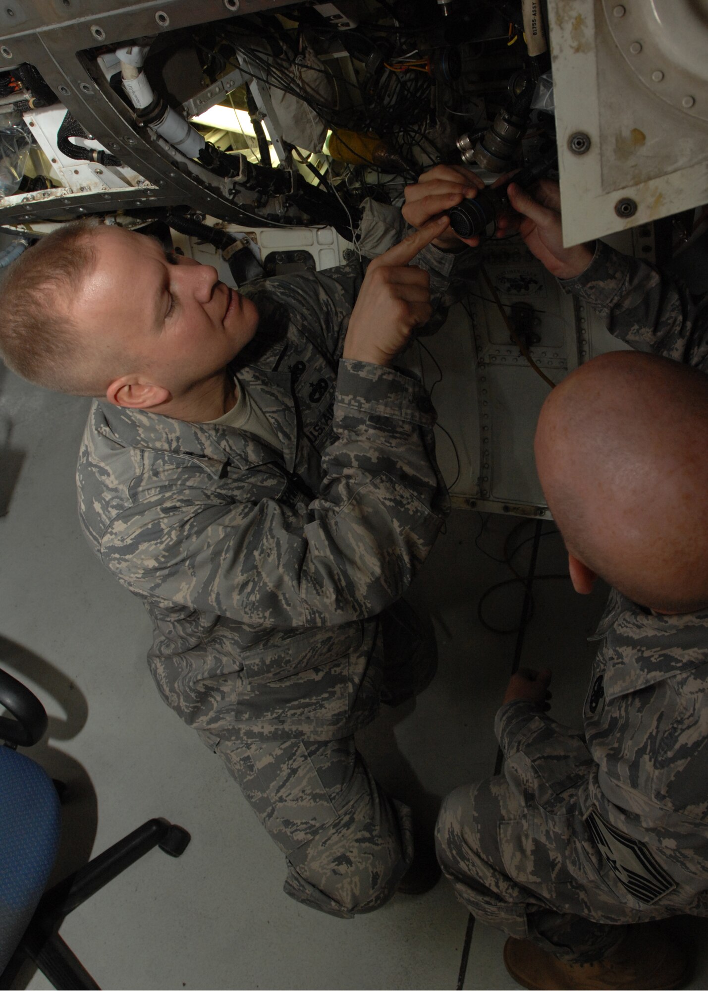 SPANGDAHLEM AIR BASE, Germany -- Capt. Robert Merwin, 52nd Equipment Maintenance Squadron, asks Senior Master Sgt. Charles Miller, 52nd EMS, about the F-16 Fighting Falcon onboard oxygen generating system Feb. 5, 2009.  The F-16 Fighting Falcon aircraft is essential for training pilots and airman in preparation for deployments and daily missions at the 52d Fighter Wing. (U.S. Air Force photo by Senior Airman Jenifer H. Calhoun)