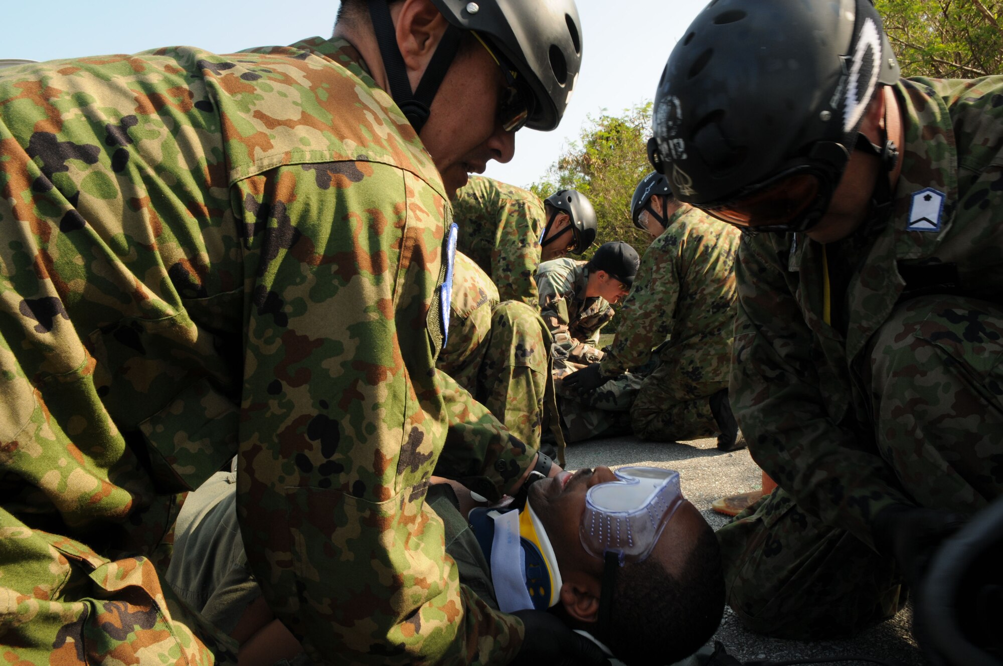 Air Recuemen from the Japanese Air Self Defense Force (JASDF) perform Self Aid Buddy Care to a victim, during exercise Cope Angel 09-1, Feb. 11, 2009. Cope Angel is a joint rescue exercise between members of the U.S. Air Force and the JASDF. (U.S. Air Force photo/Staff Sgt Chrissy Best)