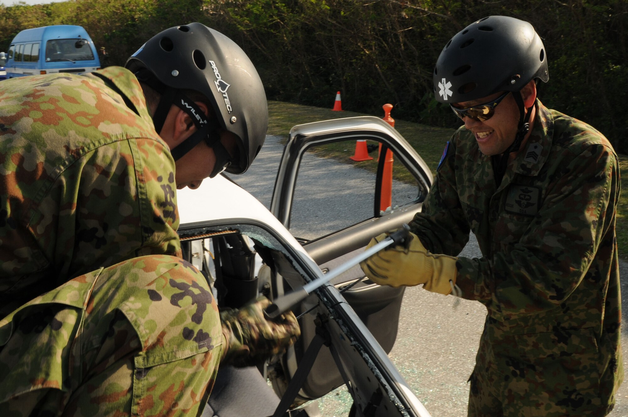 Air Recuemen from the Japanese Air Self Defense Force (JASDF) uses a hacksaw to remove the roof of a vehicle, during exercise Cope Angel 09-1, Feb. 11, 2009. Cope Angel is a joint rescue exercise between members of the U.S. Air Force and the JASDF. (U.S. Air Force photo/Staff Sgt Chrissy Best)