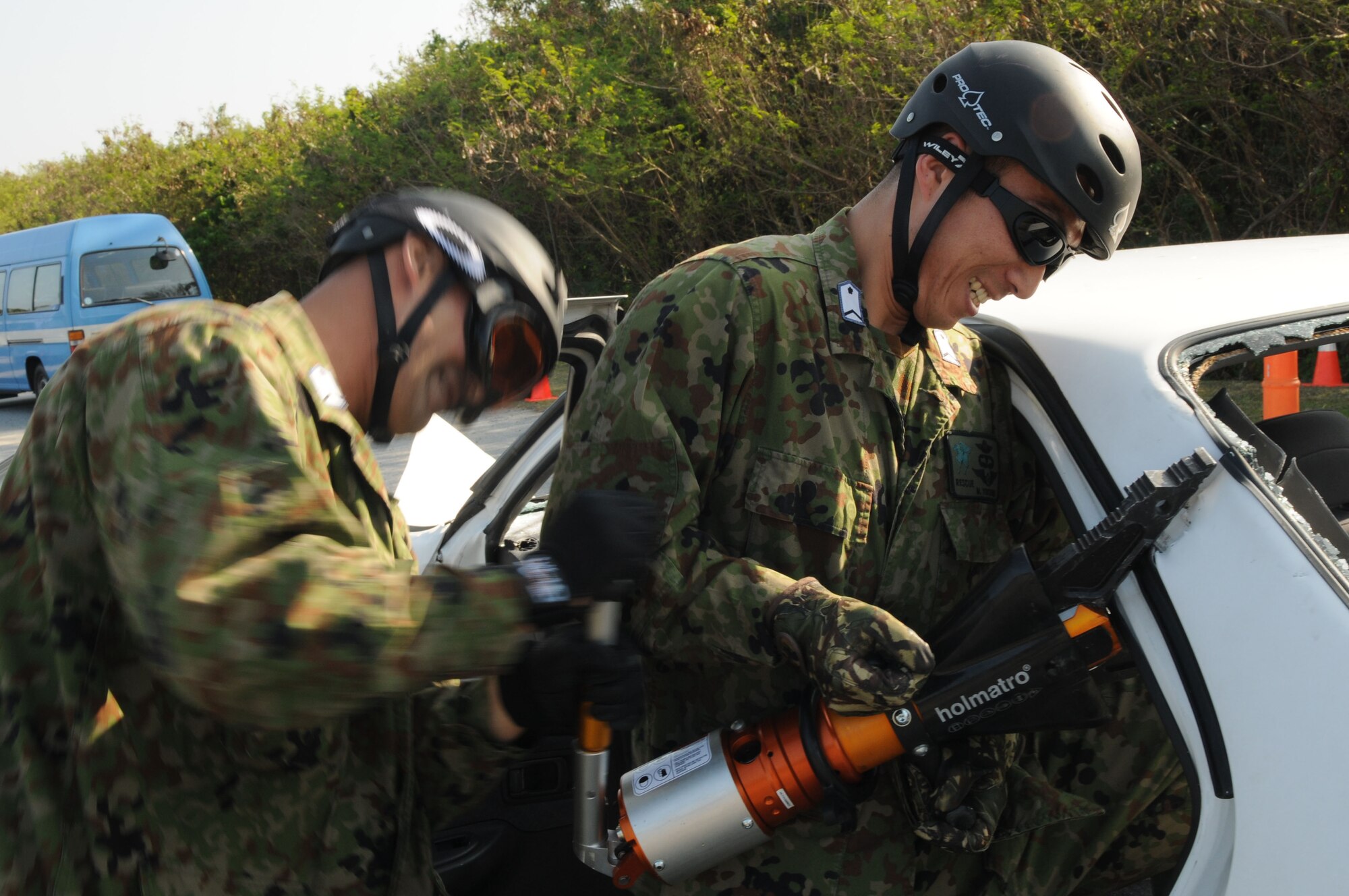 Air Recuemen from the Japanese Air Self Defense Force (JASDF) uses the jaws of life to remove the roof of a vehicle, during exercise Cope Angel 09-1, Feb. 11, 2009. Cope Angel is a joint rescue exercise between members of the U.S. Air Force and the JASDF. (U.S. Air Force photo/Staff Sgt Chrissy Best)