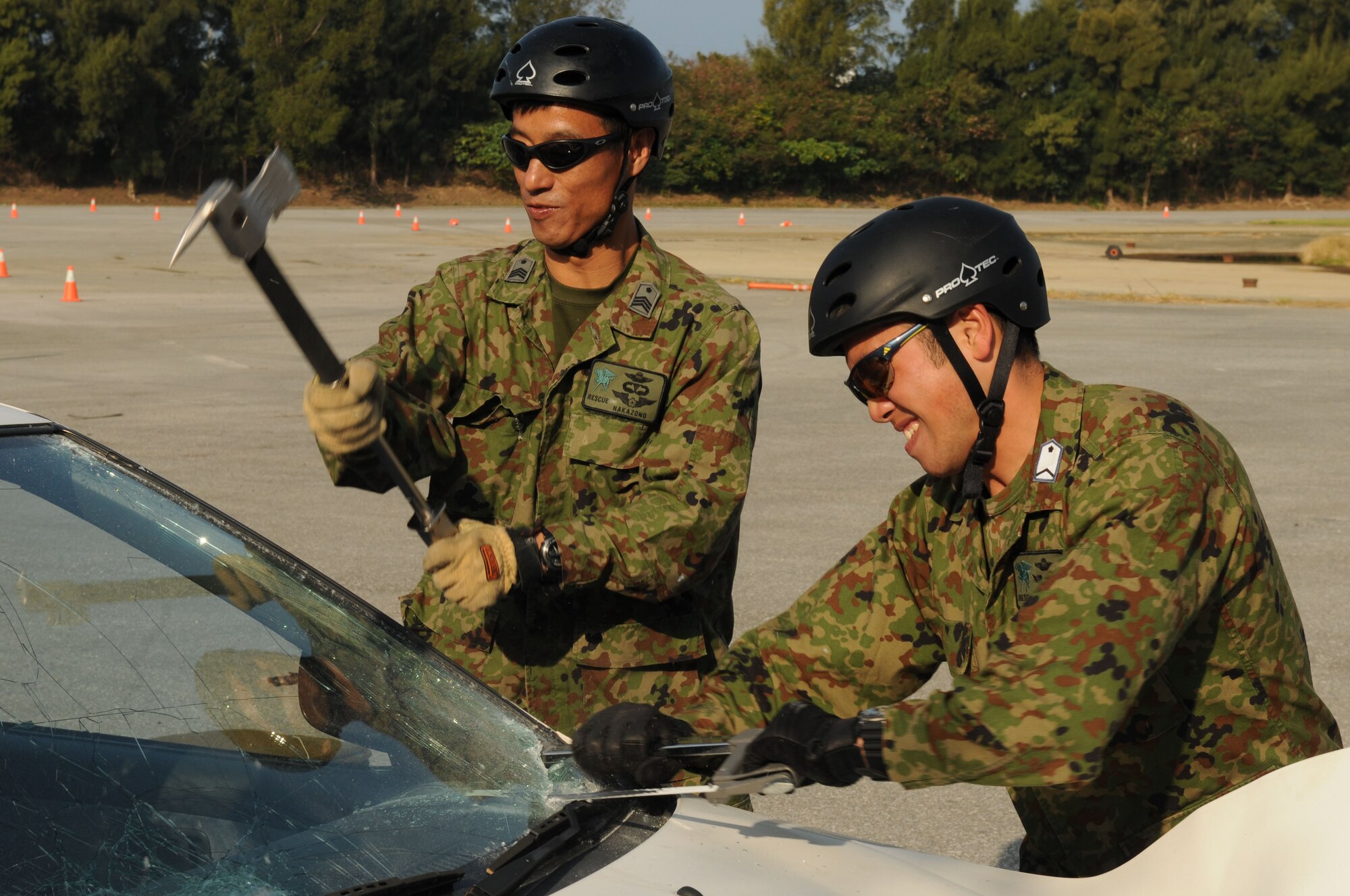 Air Recuemen from the Japanese Air Self Defense Force (JASDF) use a hacksaw and Crash Ax, to remove a car windshield, during exercise Cope Angel 09-1, Feb. 11, 2009. Cope Angel is a joint rescue exercise between members of the U.S. Air Force and the JASDF. (U.S. Air Force photo/Staff Sgt Chrissy Best)