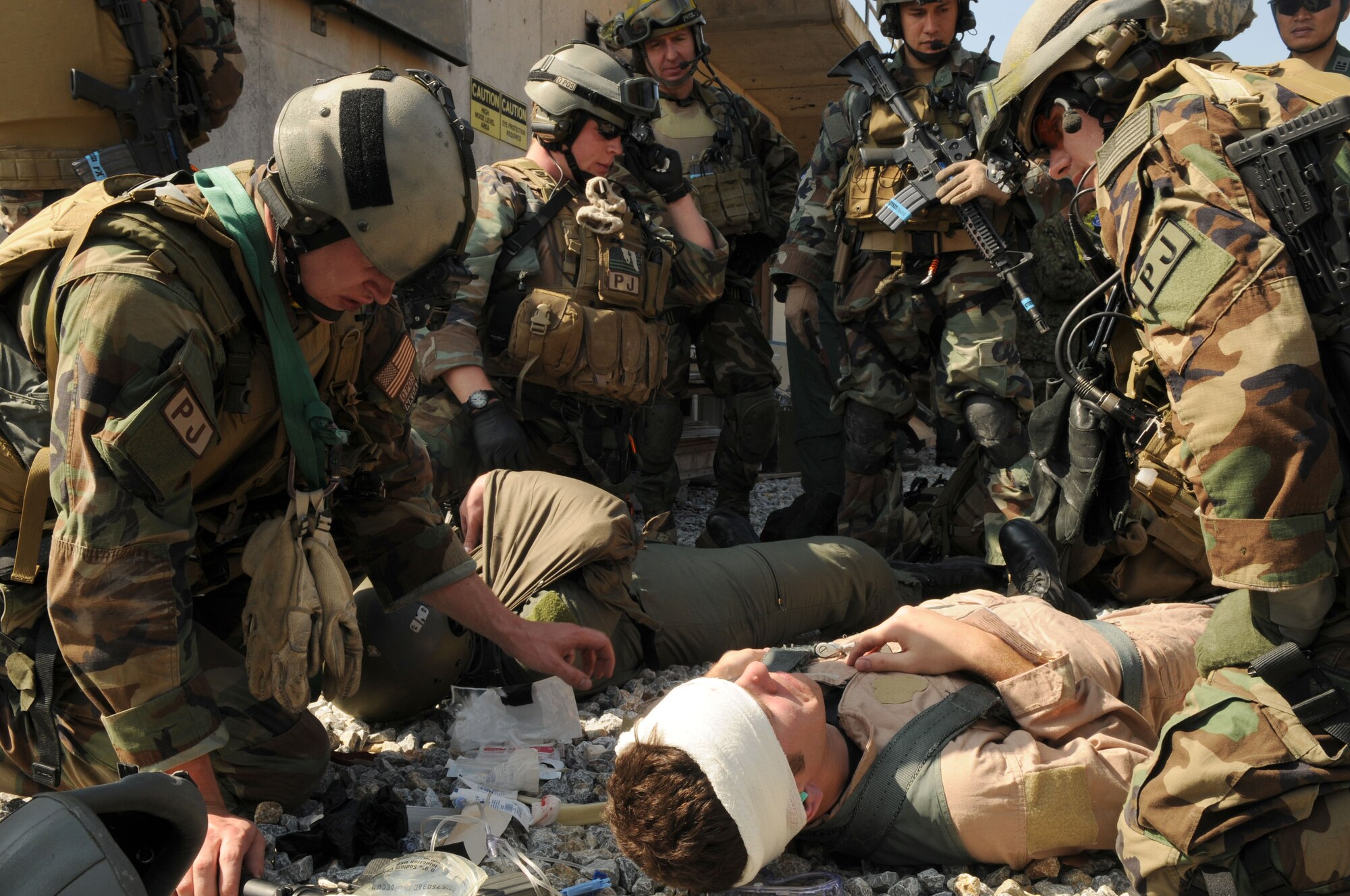 Pararescuemen assigned to 31st Rescue Squadron, Kadena Air Base, Japan perform Self Aid Buddy Care to a victim as part of a training scenario during exercise Cope Angel 09-1, Feb. 10, 2009. Cope Angel is a joint rescue exercise between members of the U.S. Air Force and the Japanese Air Self Defense Force.  (U.S. Air Force photo/Staff Sgt Chrissy Best)