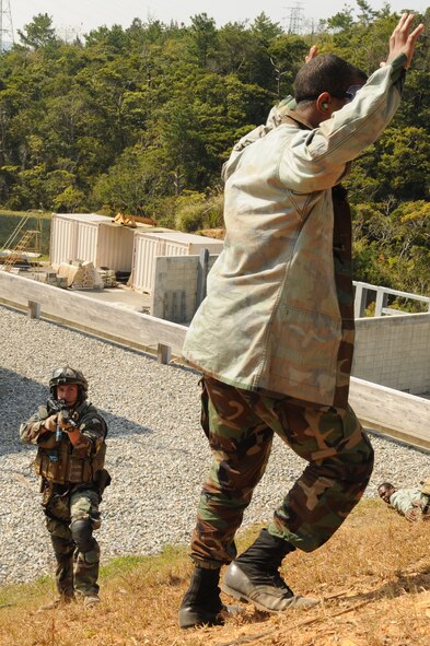 Staff Sgt. Ortega, assigned to the 31st Rescue Squadron, Kadena Air Base, Japan, apprehend a suspicious person as part of a training scenario  during exercise Cope Angel 09-1, Feb. 10, 2009. Cope Angel is a joint rescue exercise between members of the U.S. Air Force and the Japanese Air Self Defense Force.  (U.S. Air Force photo/Staff Sgt Chrissy Best)