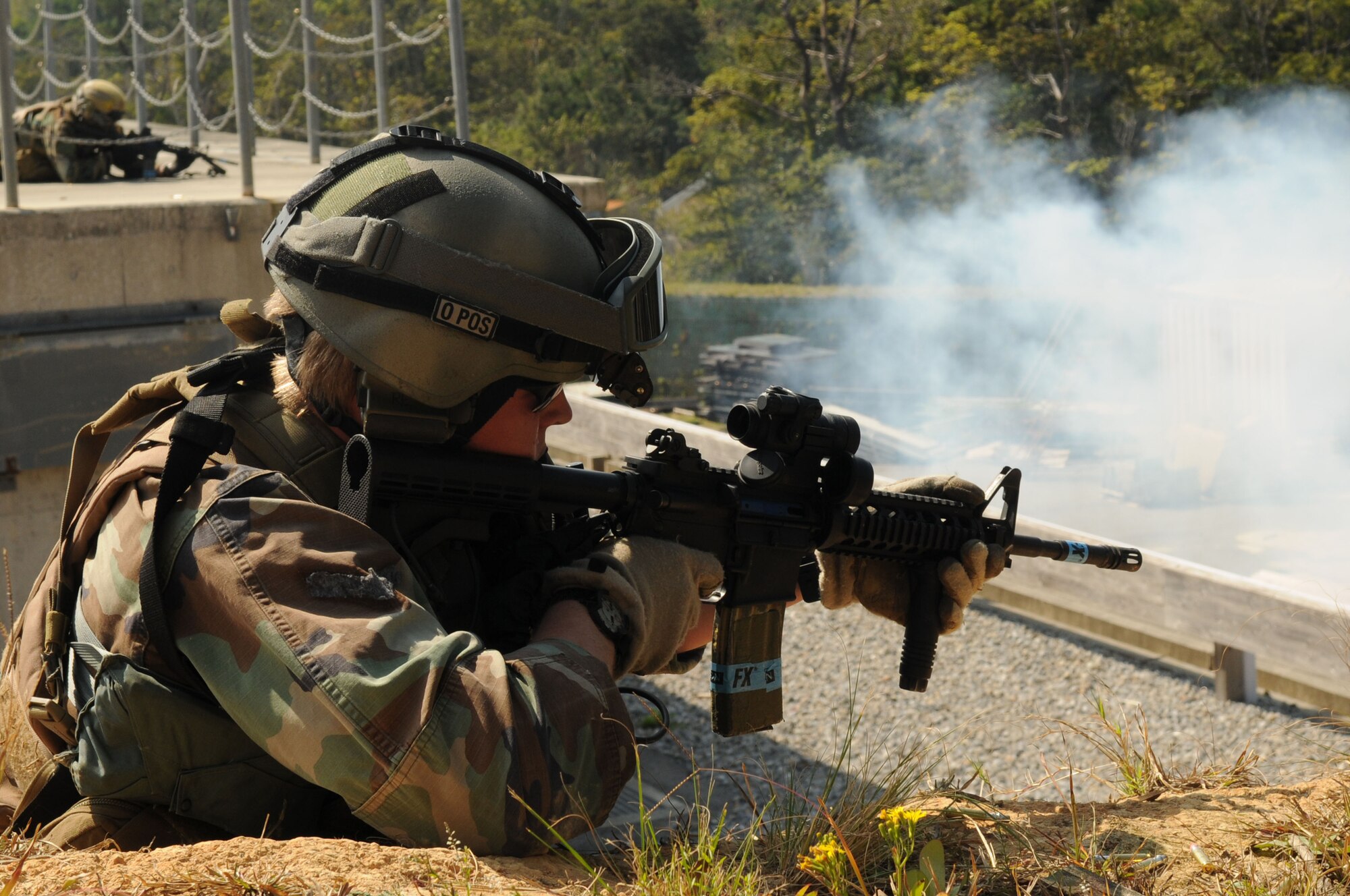 A Pararescueman assigned to the 31st Rescue Squadron Kadena Air Base, Japan, returns fire as part of a training scenario  during exercise Cope Angel 09-1, Feb. 10, 2009. Cope Angel is a joint rescue exercise between members of the U.S. Air Force and the Japanese Air Self Defense Force.  (U.S. Air Force photo/Staff Sgt Chrissy Best)