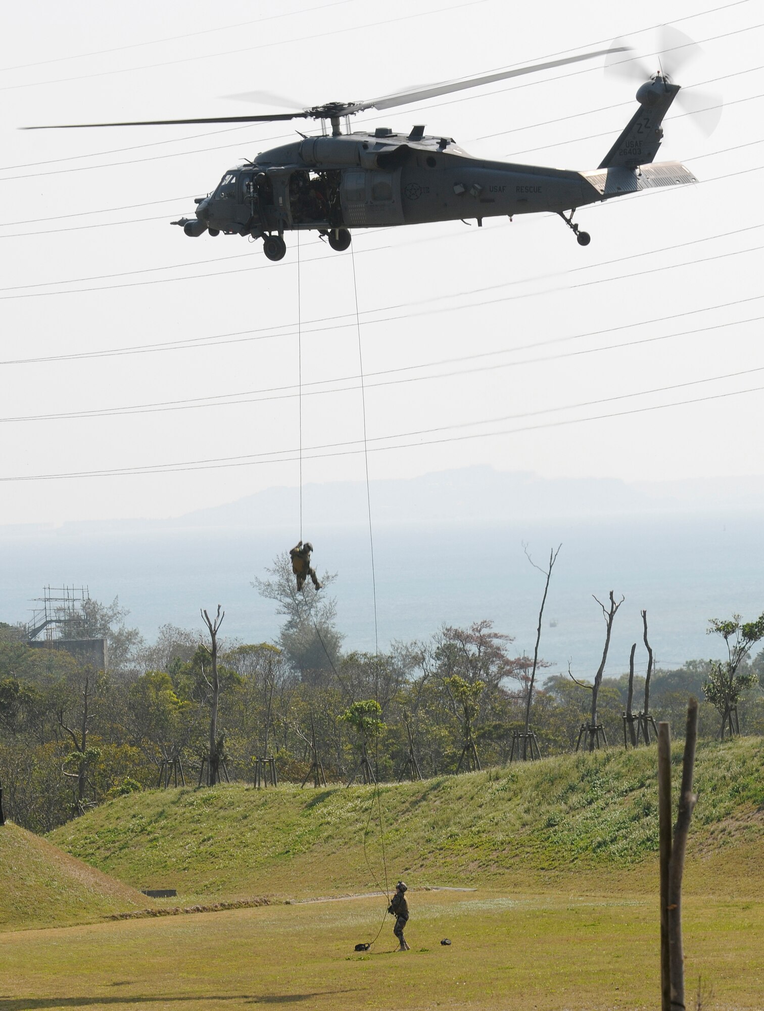 Pararescuemen assigned to 31st Rescue Squadron at Kadena Air Base, Japan rappel from an HH-60 Pave Hawk helicopter during exercise Cope Angel 09-1, Feb. 10, 2009. Cope Angel is a joint rescue exercise between members of the U.S. Air Force and the Japanese Air Self Defense Force. (U.S. Air Force photo/Airman 1st Class Chad Warren)