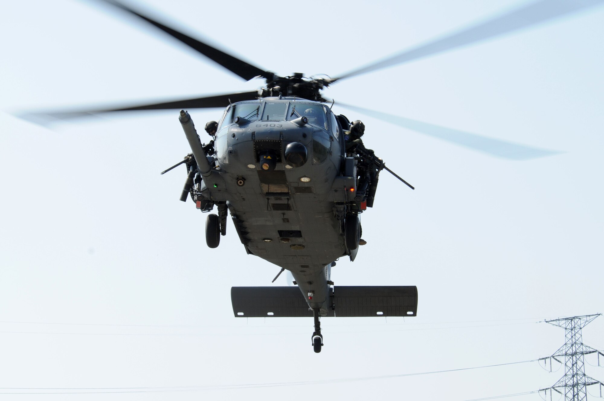 An HH-60 Pave Hawk flies over Camp Hansen training area, during exercise Cope Angel 09-1, Feb. 10, 2009. Cope Angel is a joint rescue exercise between members of the U.S. Air Force and the Japanese Air Self Defense Force.  (U.S. Air Force photo/Staff Sgt Chrissy Best)
