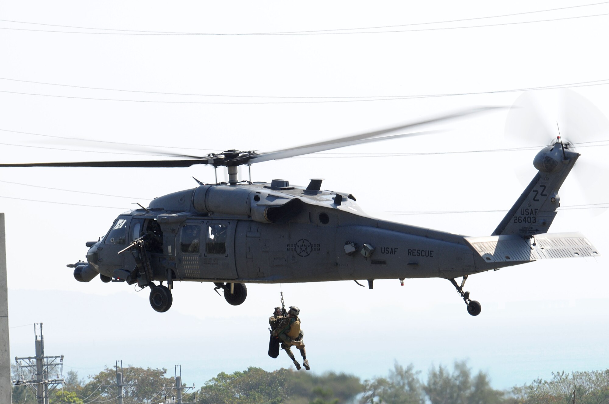 Pararescuemen assigned to 31st Rescue Squadron at Kadena Air Base, Japan are hoisted into an HH-60 Pave Hawk helicopter during exercise Cope Angel 09-1, Feb. 10, 2009. Cope Angel is a joint rescue exercise between members of the U.S. Air Force and the Japanese Air Self Defense Force.  (U.S. Air Force photo/Staff Sgt Chrissy Best)