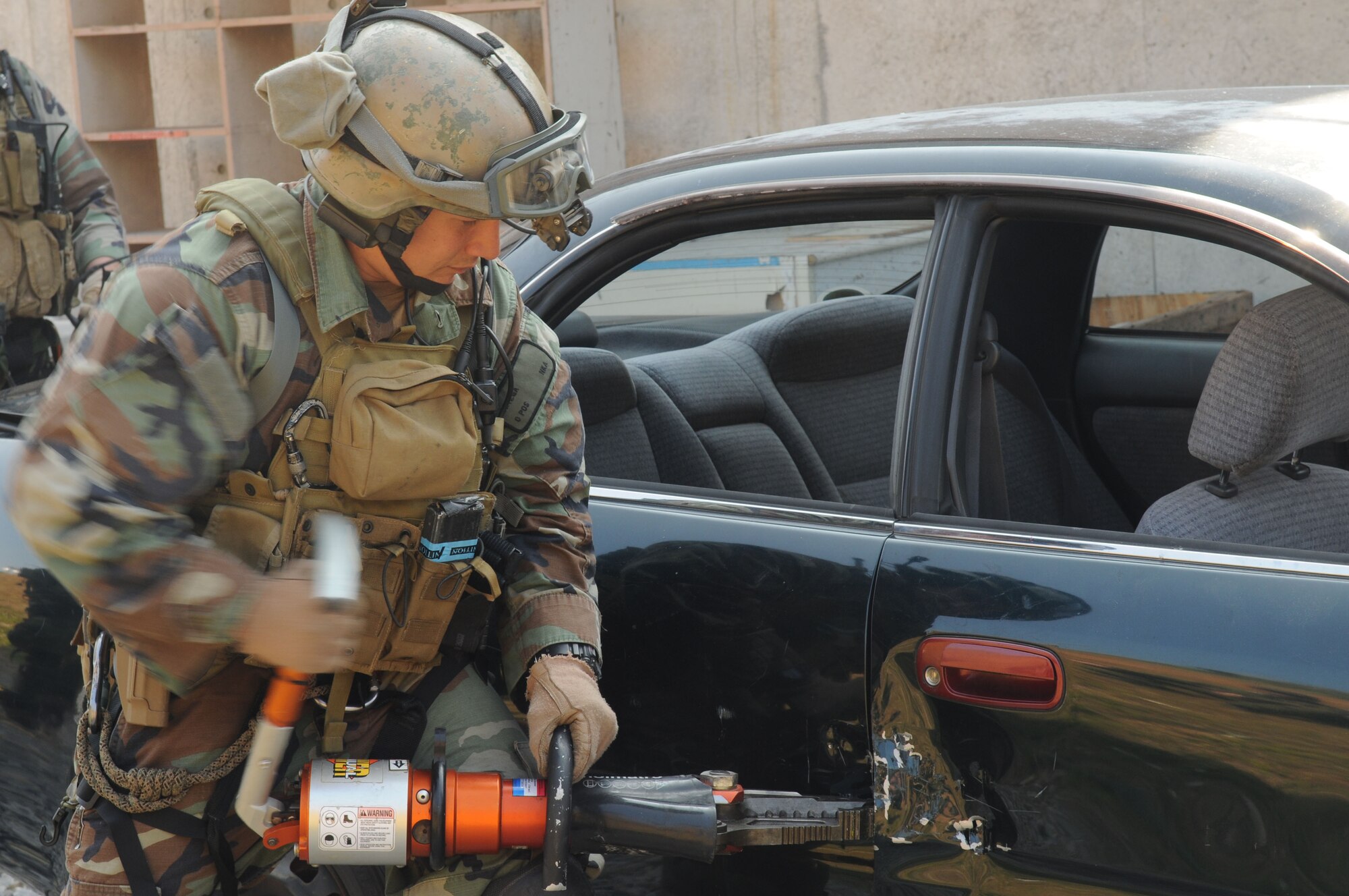 Staff Sgt. Ortega a pararescueman assigned to the 31st Rescue Squadron, Kadena Air Base, Japan, uses the jaws of life to force open a car door during exercise Cope Angel 09-1, Feb. 10, 2009. Cope Angel is a joint rescue exercise between members of the U.S. Air Force and the Japanese Air Self Defense Force. (U.S. Air Force photo/Staff Sgt Chrissy Best)