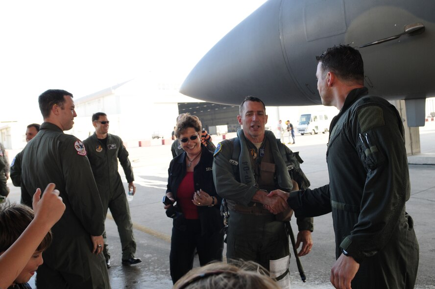 Lt. Col. Robert Novotny, 67th Fighter Squadron commander, receives congratulations from Brig. Gen. Brett Williams, 18th Wing commander after both men completed a local training mission Feb. 12 at Kadena Air Base, Japan. On this mission, Colonel Novotny became one of only four pilots at Kadena to have surpassed 2,000 flying hours in the F-15. (U.S. Air Force photo/Staff Sgt. Darnell Cannady)