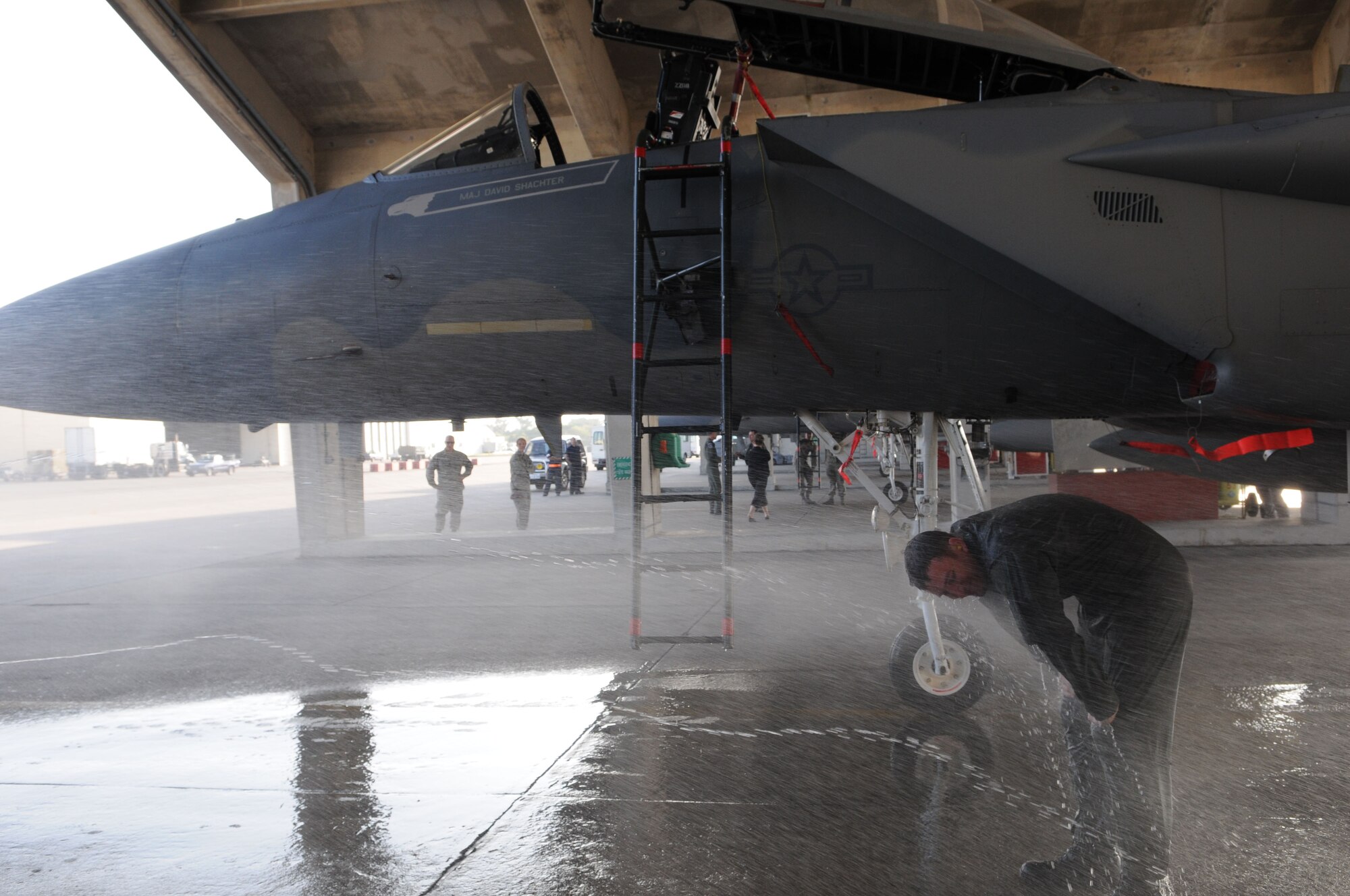 Lt. Col. Robert Novotny, 67th Fighter Squadron commander, receives a congratulatory fire hose shower upon his return from a local training mission Feb. 12, 2009 at Kadena Air Base, Japan. On this mission, Colonel Novotny became one of only four pilots at Kadena to have surpassed 2,000 flying hours in the F-15 (U.S. Air Force photo/Staff Sgt. Darnell Cannady).