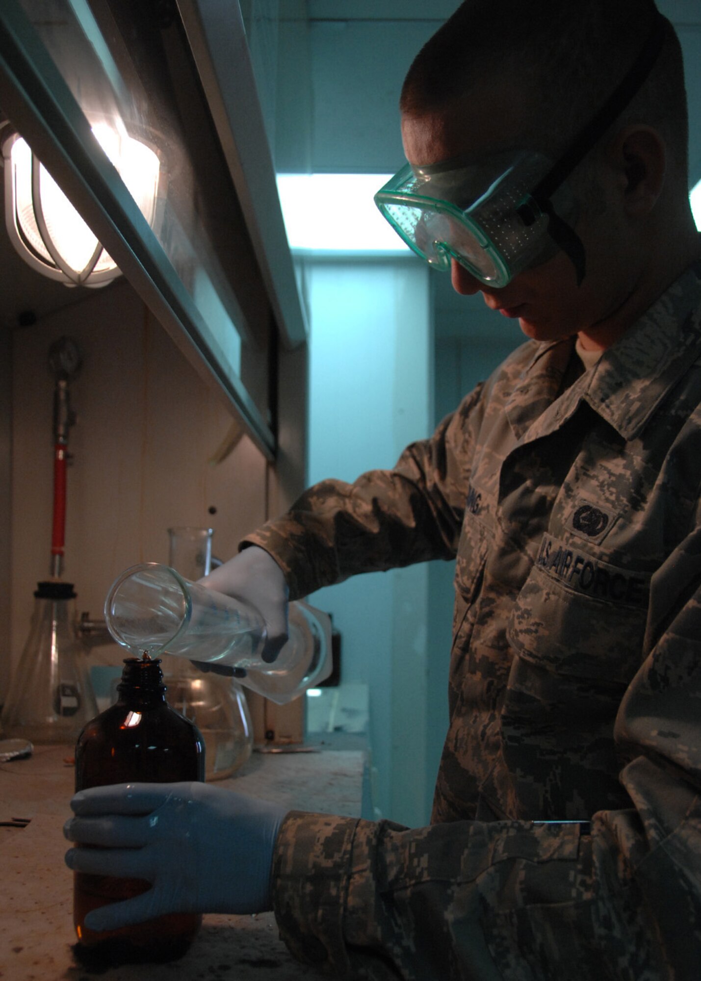 SOUTHWEST ASIA -- Senior Airman Matthew Young, 386th Expeditionary Logistics Readiness Squadron, transfers fuel into a bottle in preparation to perform a Static Dissipater Additive test at an air base in Southwest Asia, Feb. 12. The SDA test checks the conductivity of the jet fuel to ensure it's capabilities of dissipating static charges that build in fuel dissipate within an acceptable range. Airman Young is deployed from RAF Lakenheath, England, and is originally from Dallas. (U.S. Air Force photo/Senior Airman Courtney Richardson)