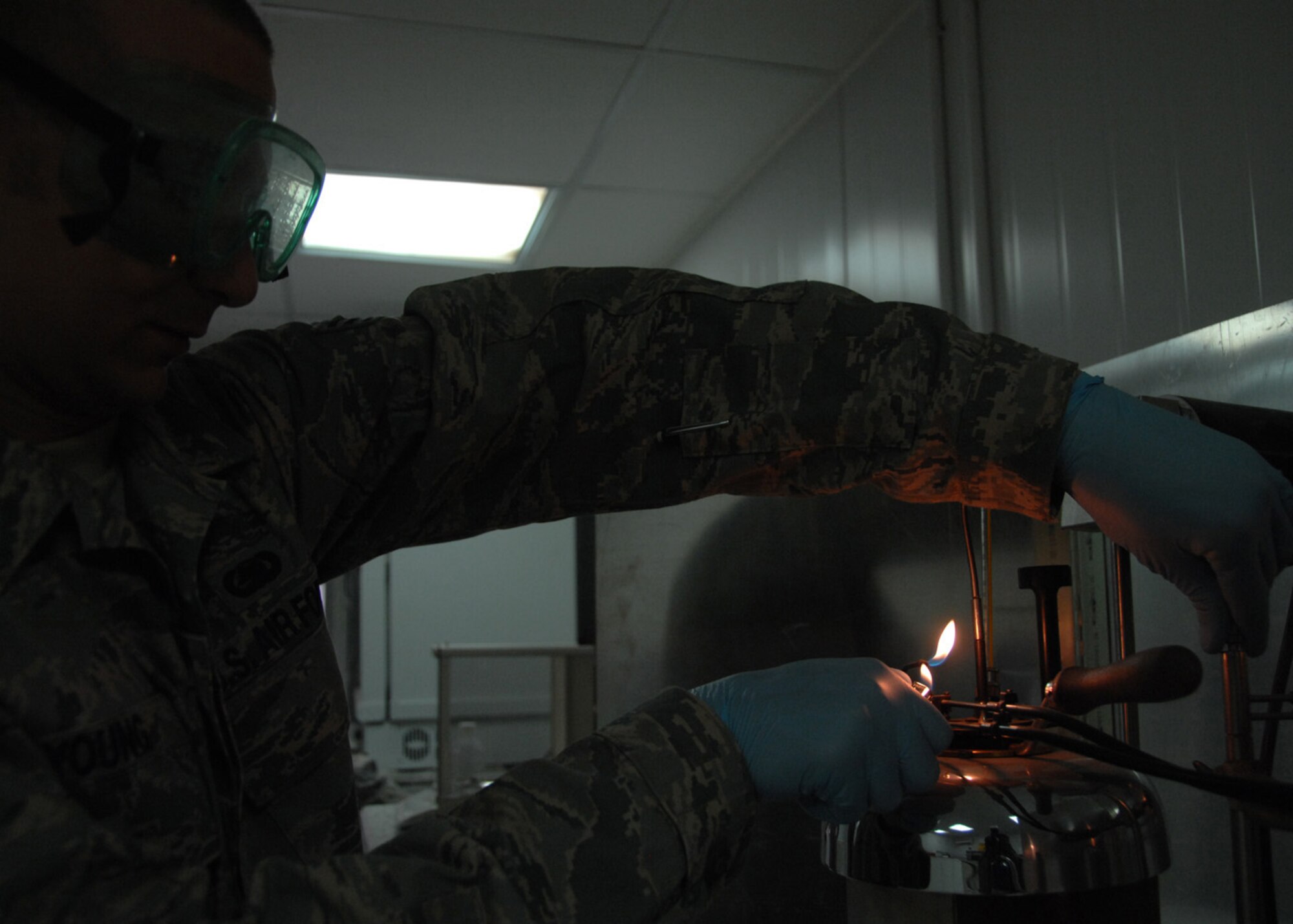SOUTHWEST ASIA -- Senior Airman Matthew Young, 386th Logistics Readiness Squadron, performs a Flash Test on a sample of jet fuel at an air base in Southwest Asia, Feb. 12. The test determines the lowest temperature at which vapours from a test portion combine with air to give a flammable mixture, also know as the flash point. Airman Young is deployed from RAF Lakenheath, England, and is from Dallas. (U.S. Air Force photo/Senior Airman Courtney Richardson)