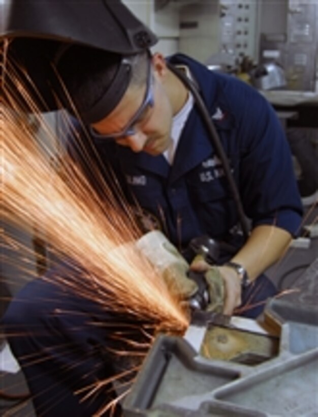 U.S. Navy Petty Officer 3rd Class James Engling grinds burs from a piece of metal after welding it in the sheet metal shop aboard the aircraft carrier USS John C. Stennis (CVN 74) in the Pacific Ocean on Feb. 6, 2009.  The Stennis is on a six-month deployment to the Western Pacific.  